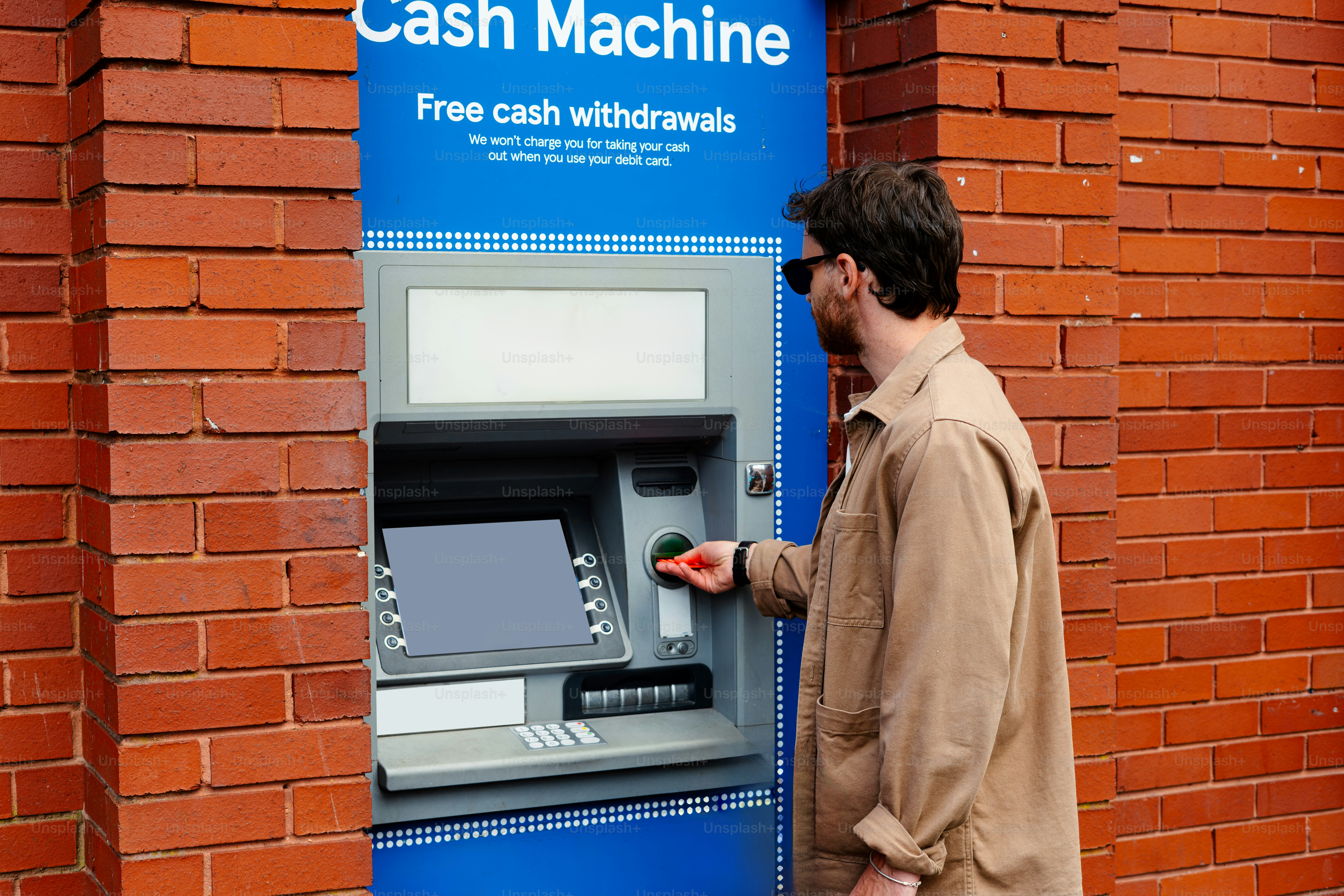 Man using an atm machine outside