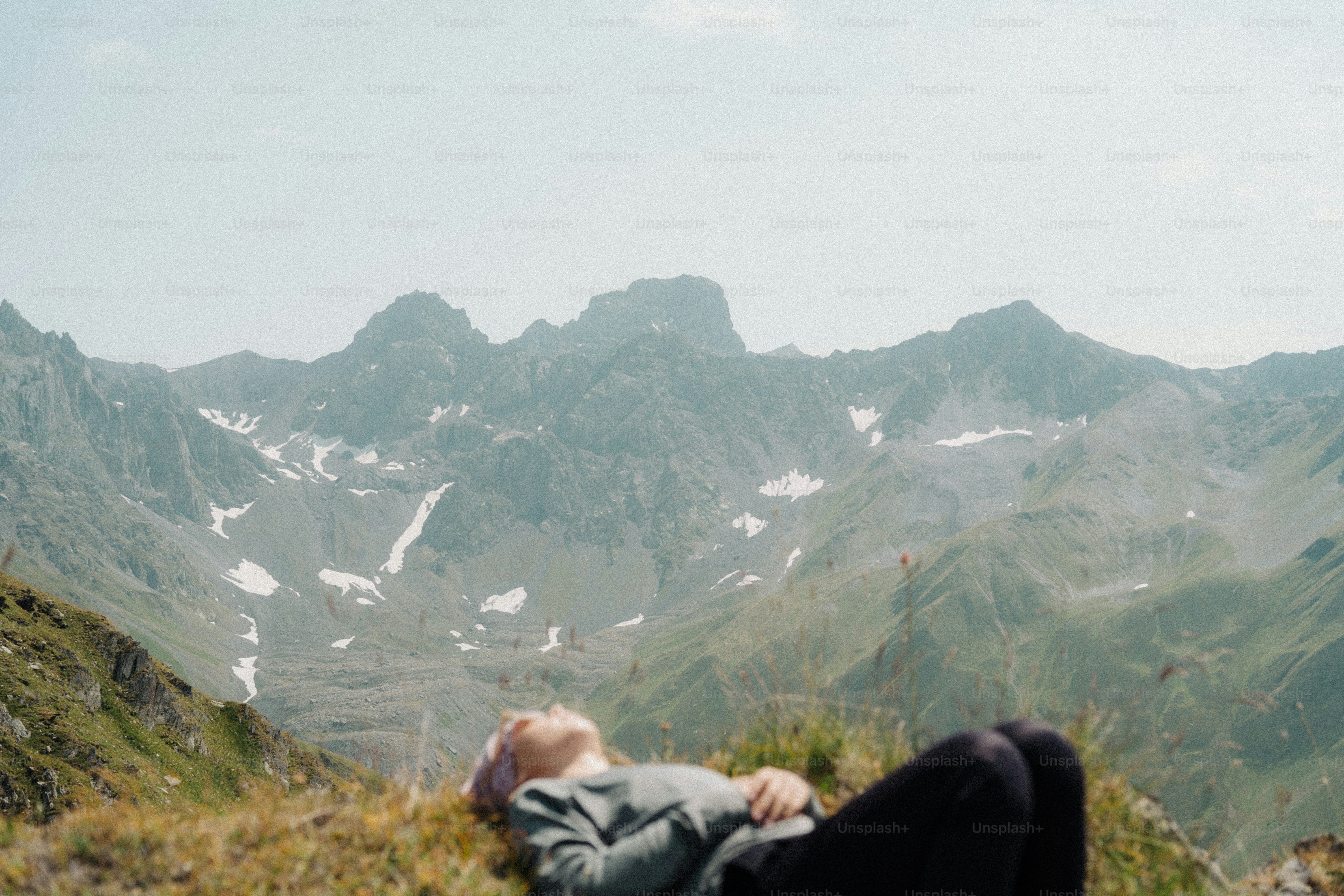 An image of a lady laying on top of a hill