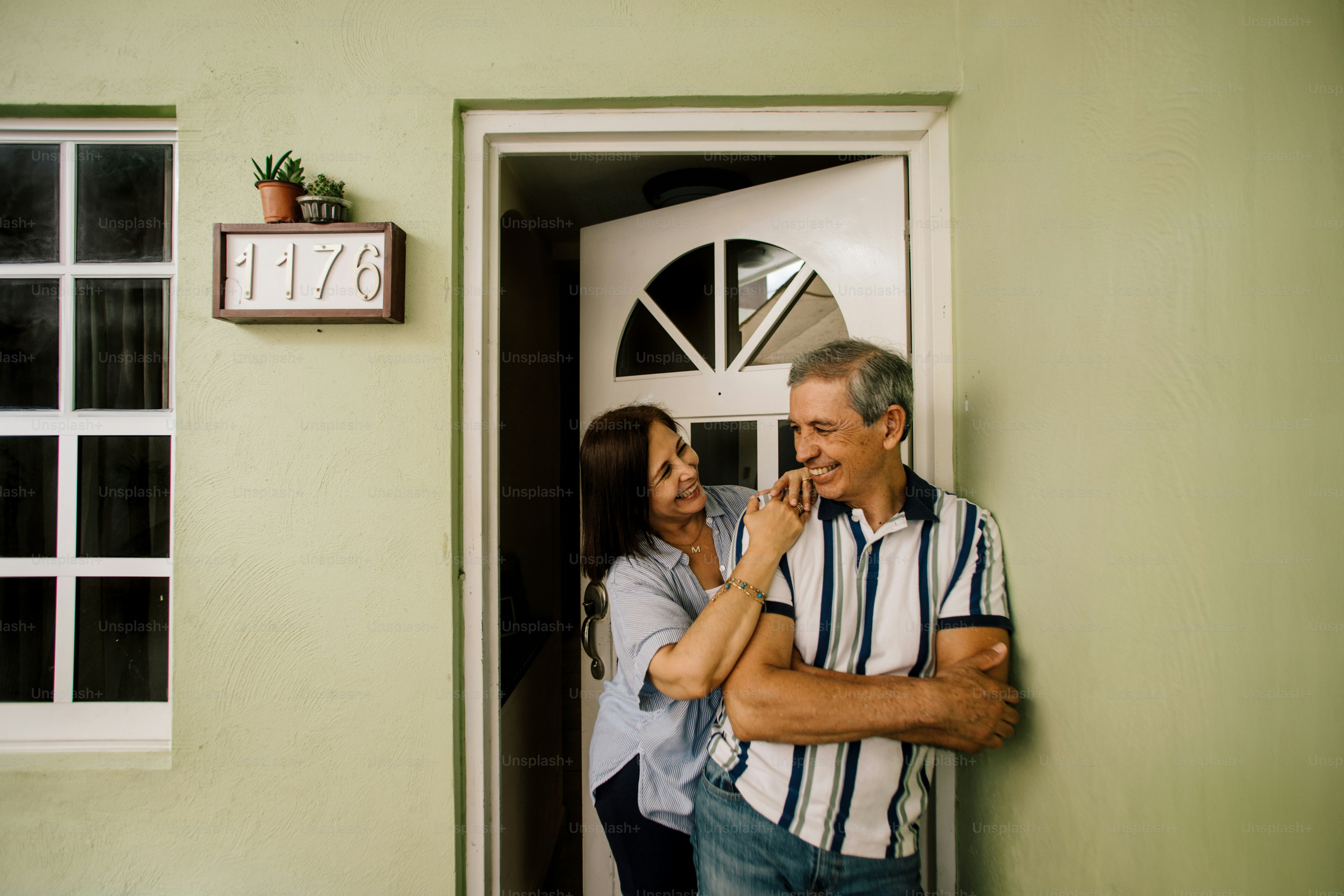 Couple standing in a doorway, looking at each other