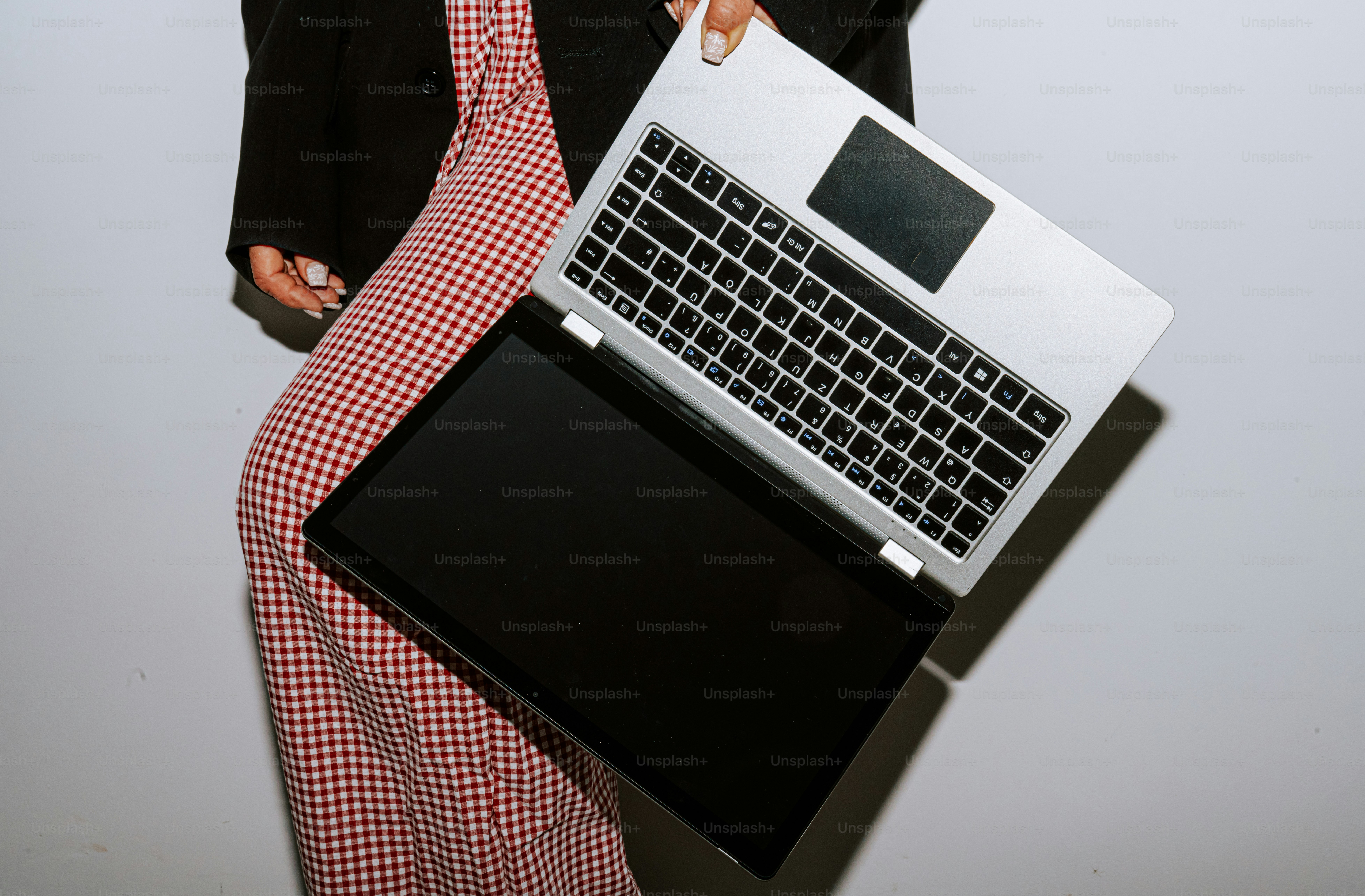 Person holding an open laptop computer