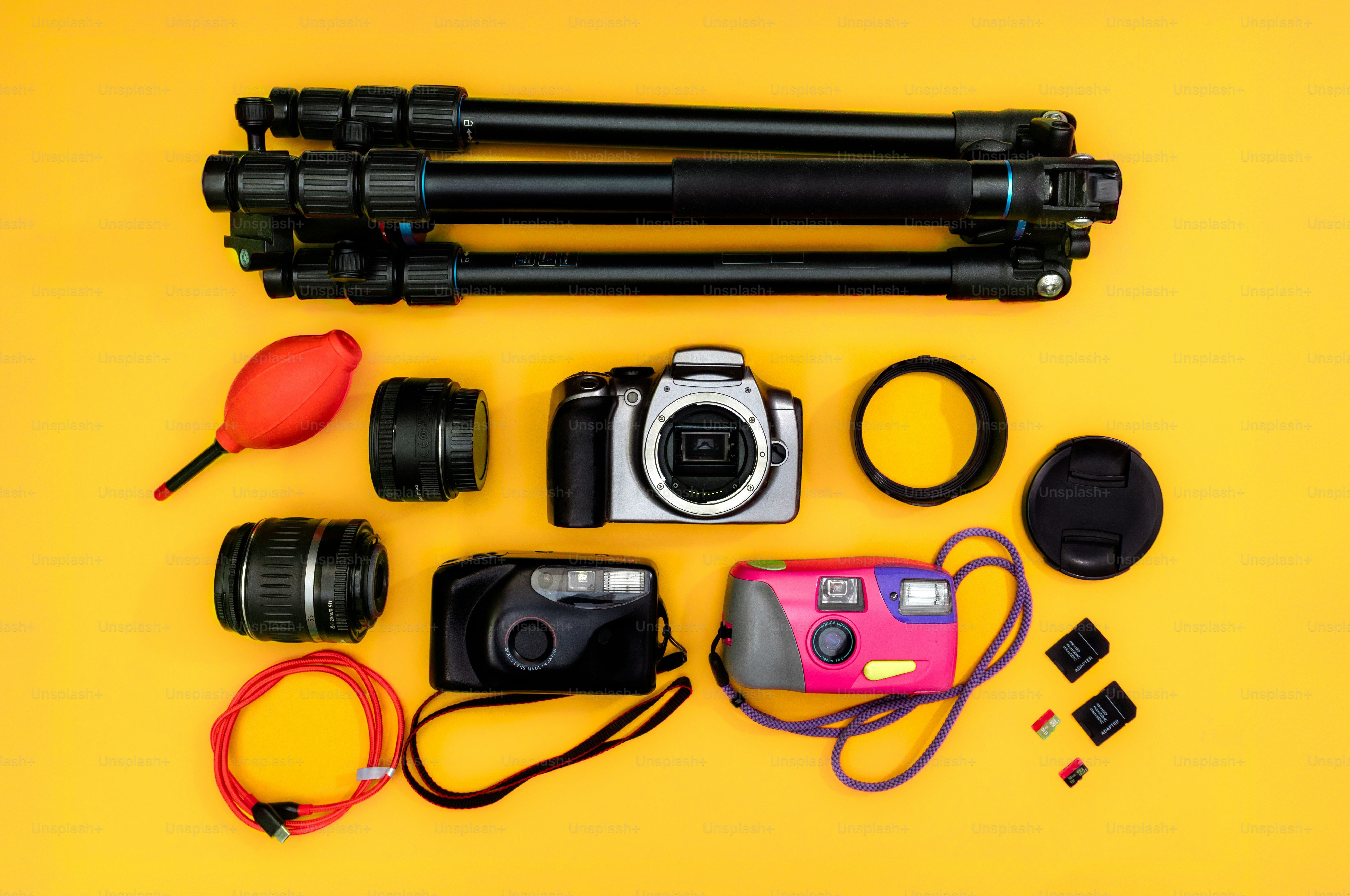 Photography equipment laid out on a yellow background