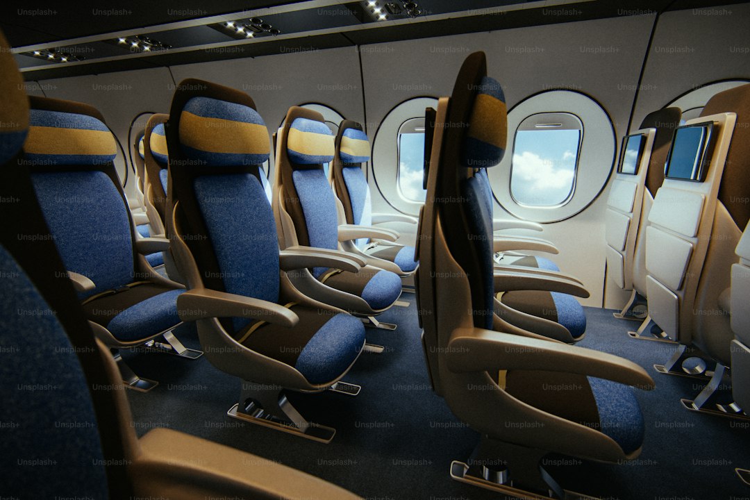 Empty airplane cabin with rows of seats.