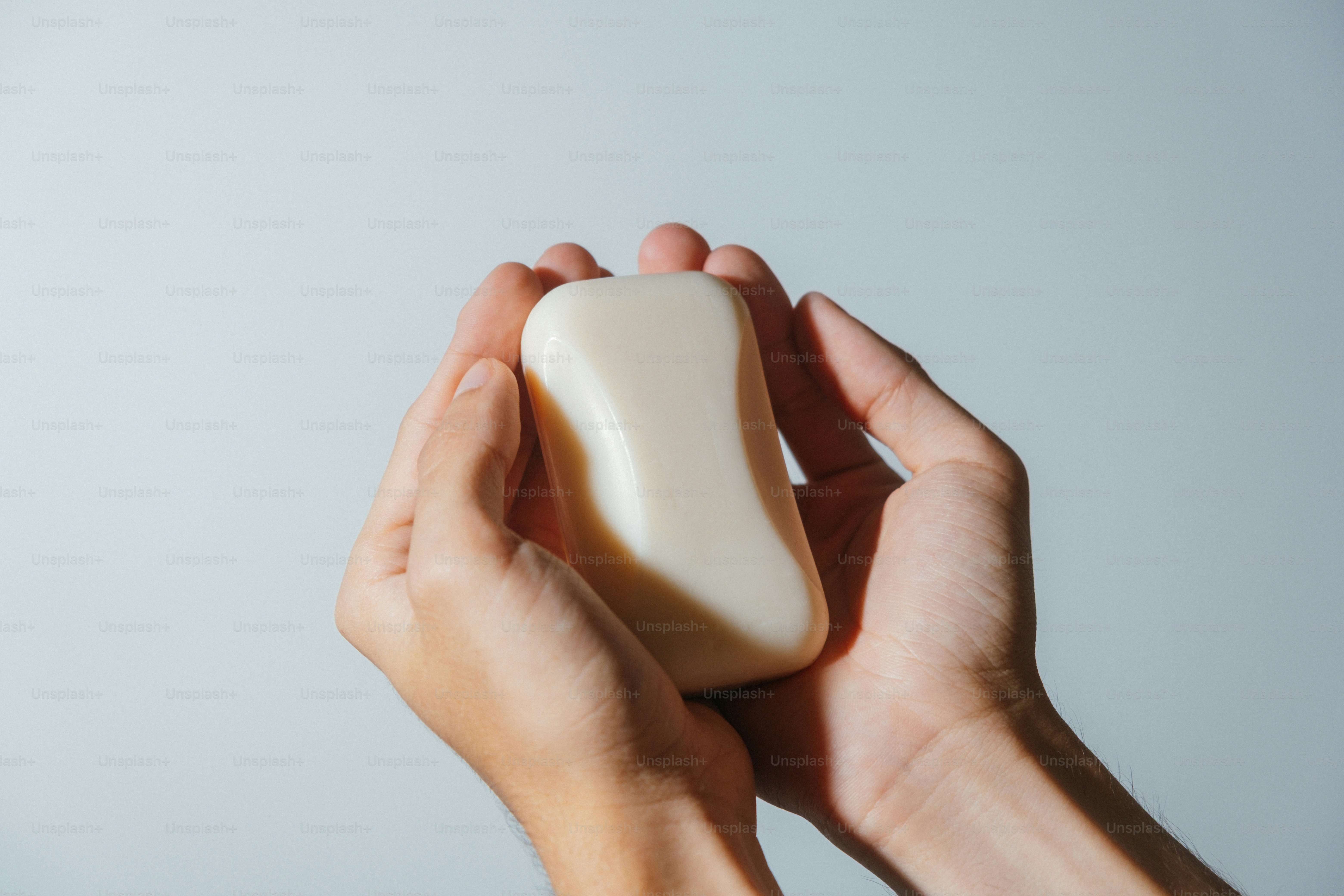 Hands holding a bar of soap