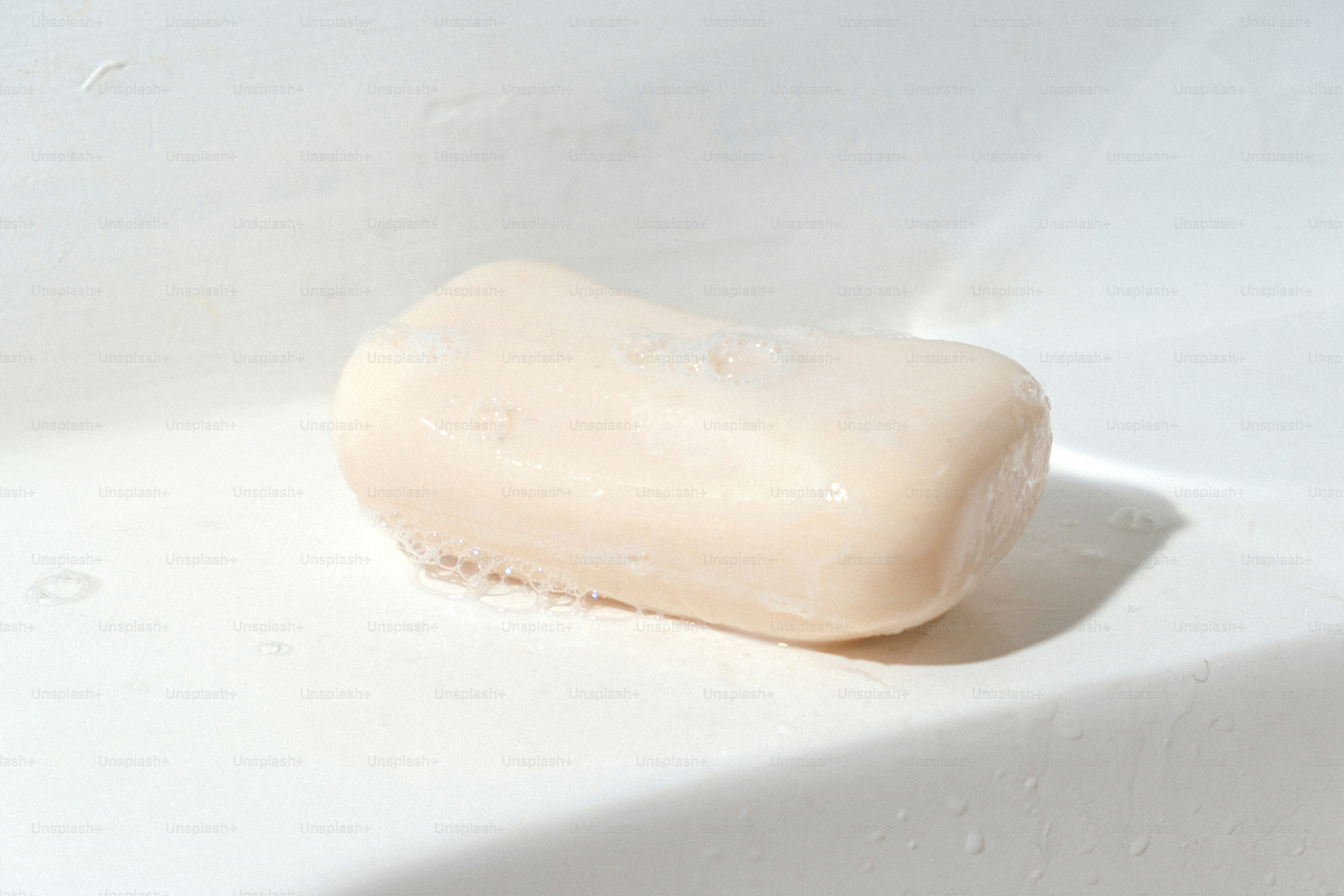 A bar of soap rests on a white sink.