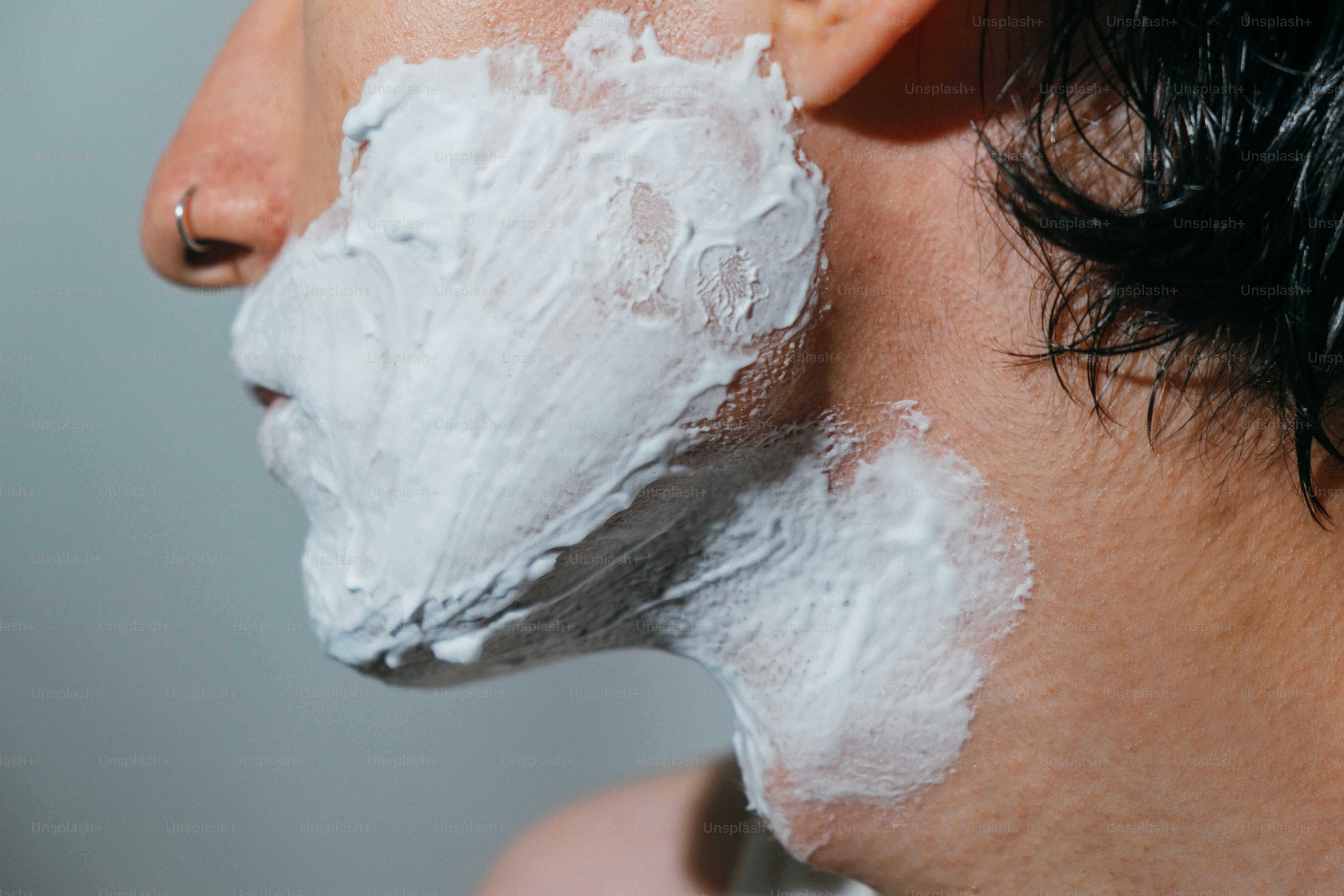 Close-up of a person's face covered in shaving cream.