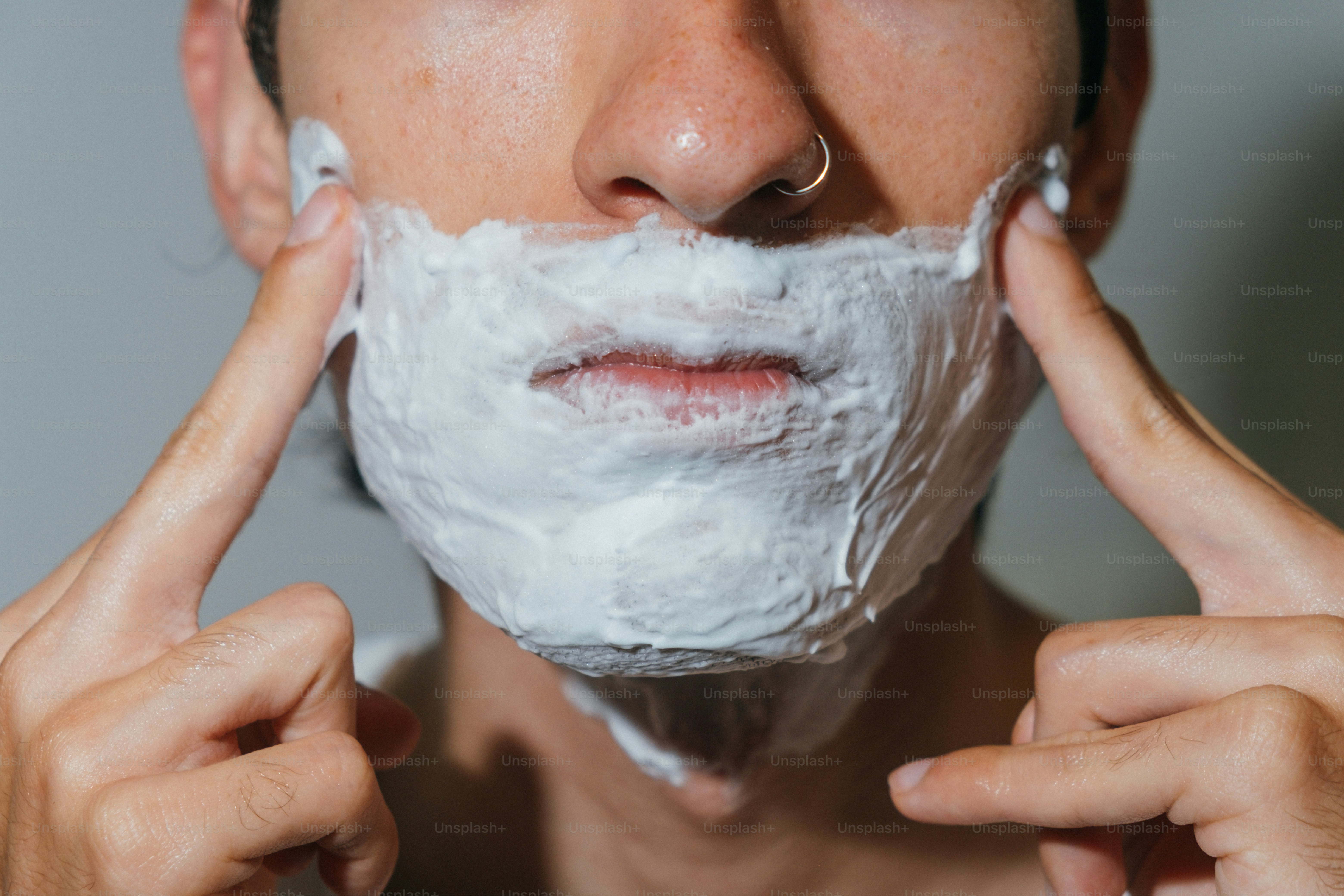 Person applying shaving cream to face