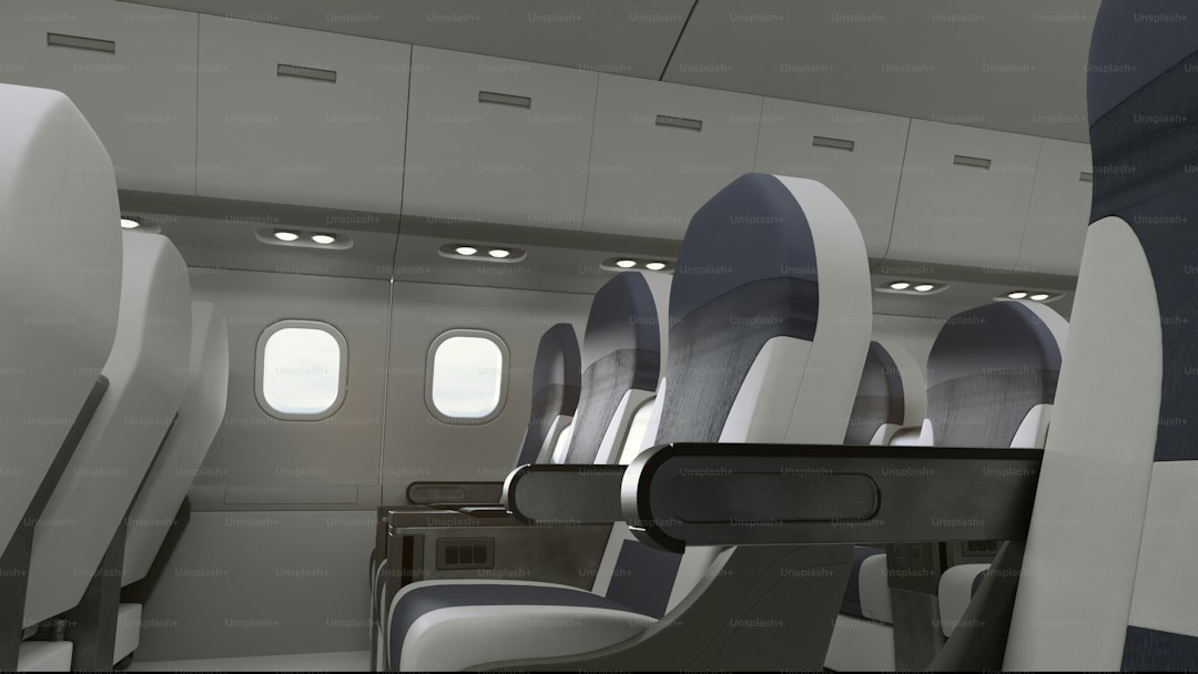 Empty airplane cabin with rows of seats.