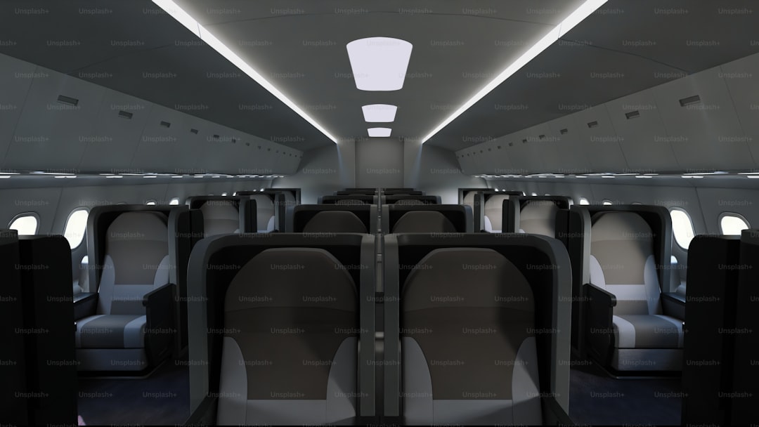 Modern train interior with empty seats and overhead lighting