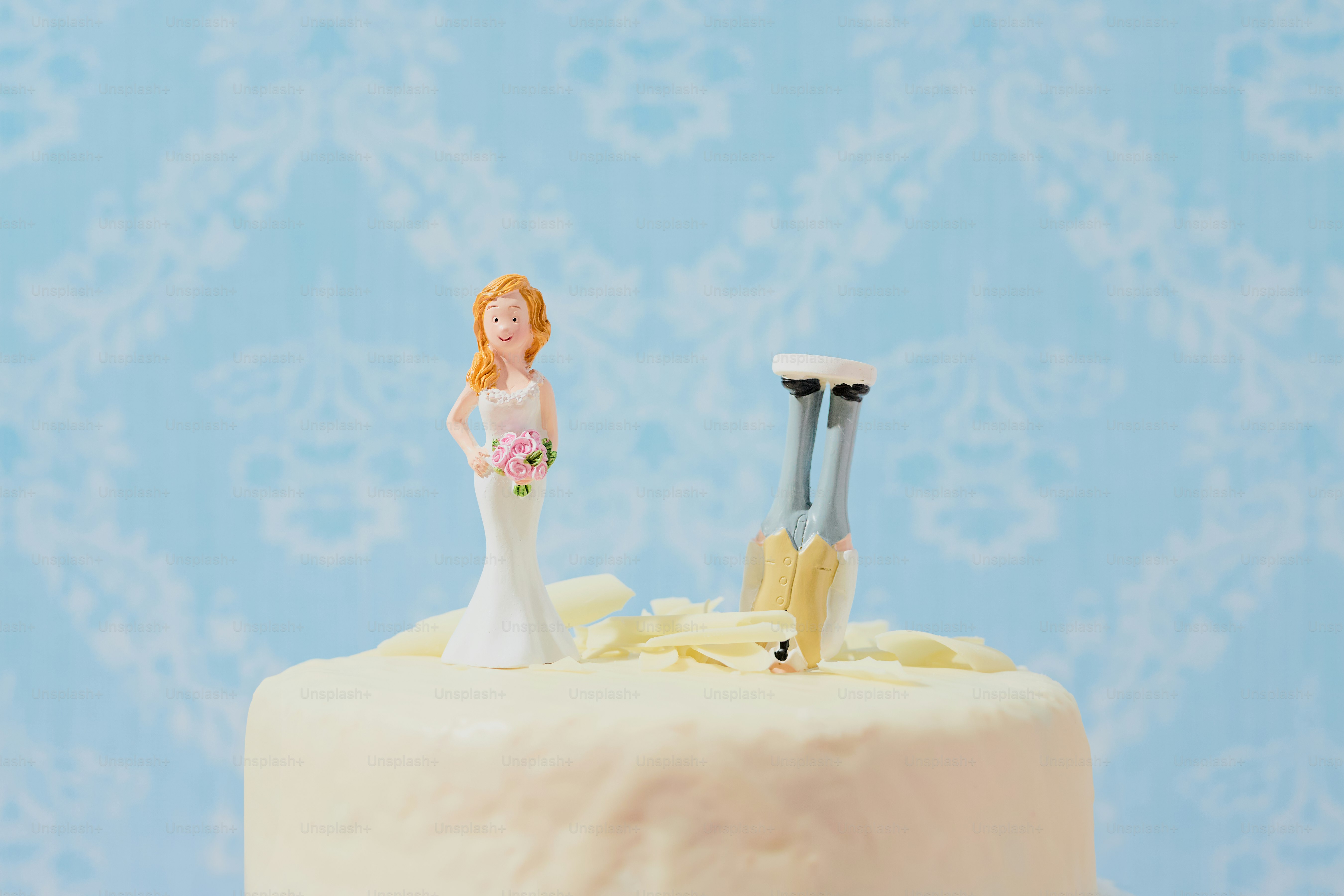 Bride and groom cake toppers on a wedding cake