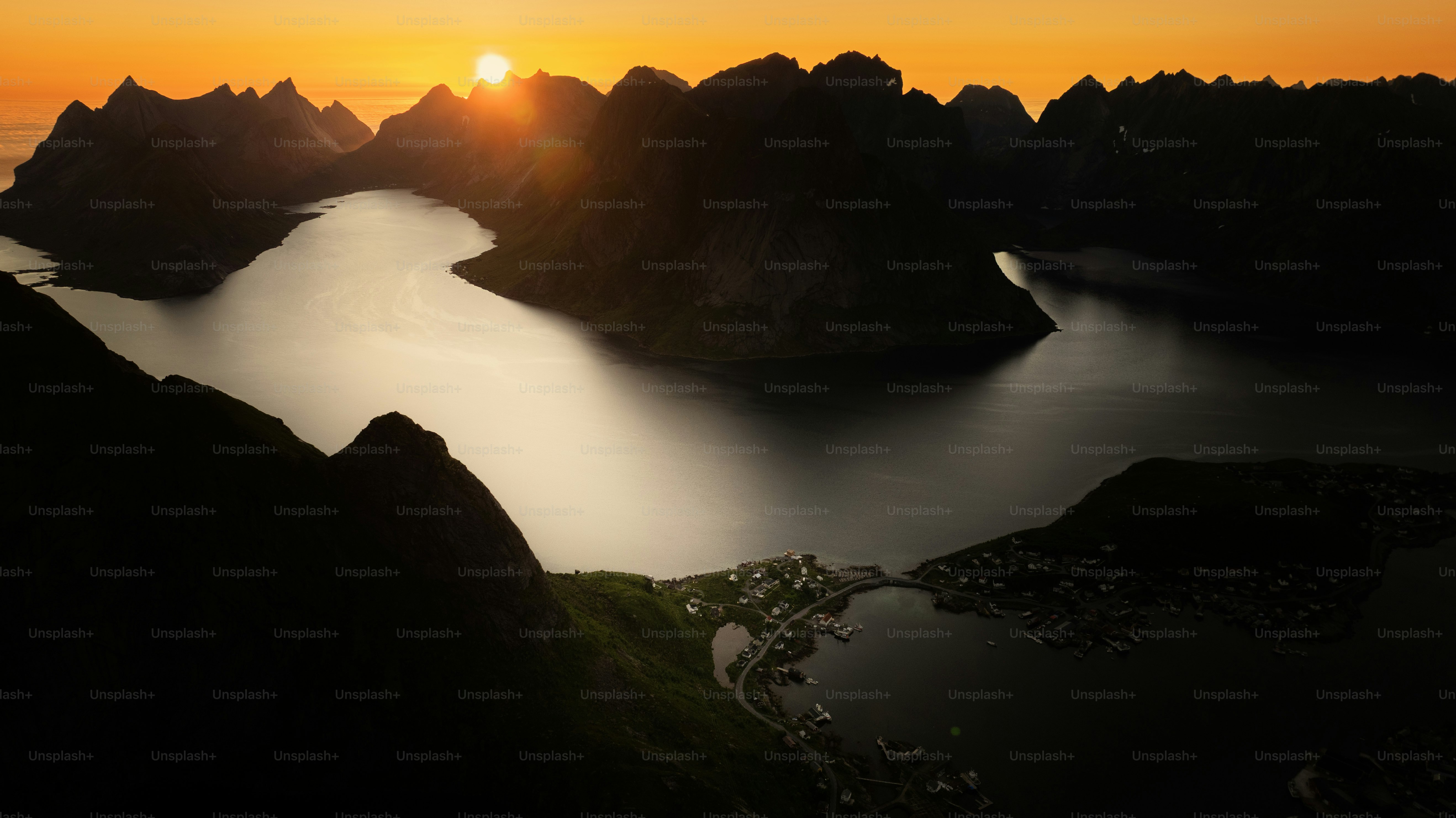 Sunset over a tranquil bay surrounded by mountains photo – Travel Image ...