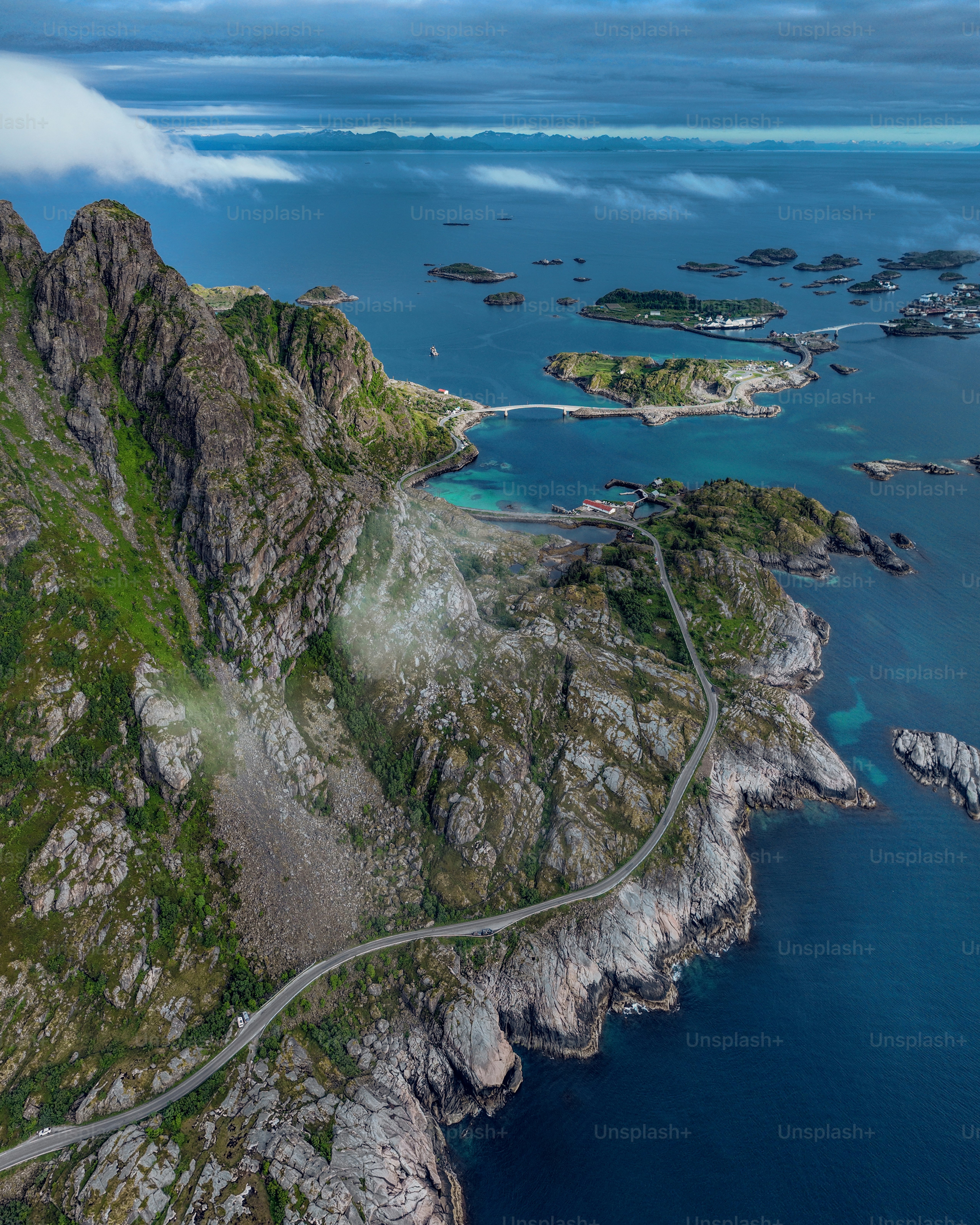 An image of a scenic coastal road winding through rocky ireland and moutain