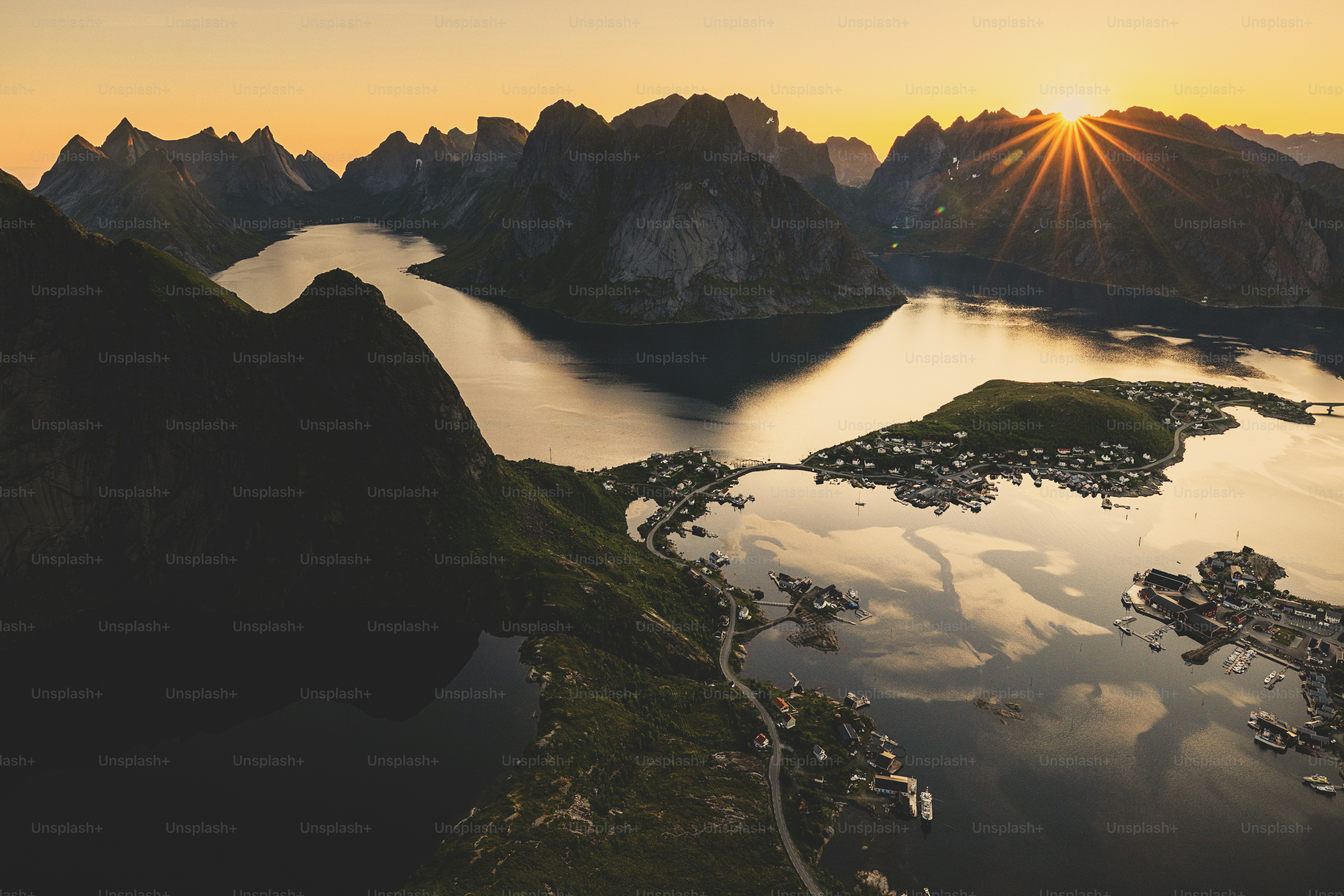 Sunset over a norwegian fjord with mountains.
