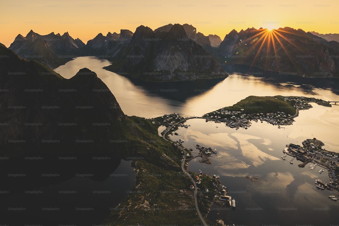 Sunset over a norwegian fjord with mountains.
