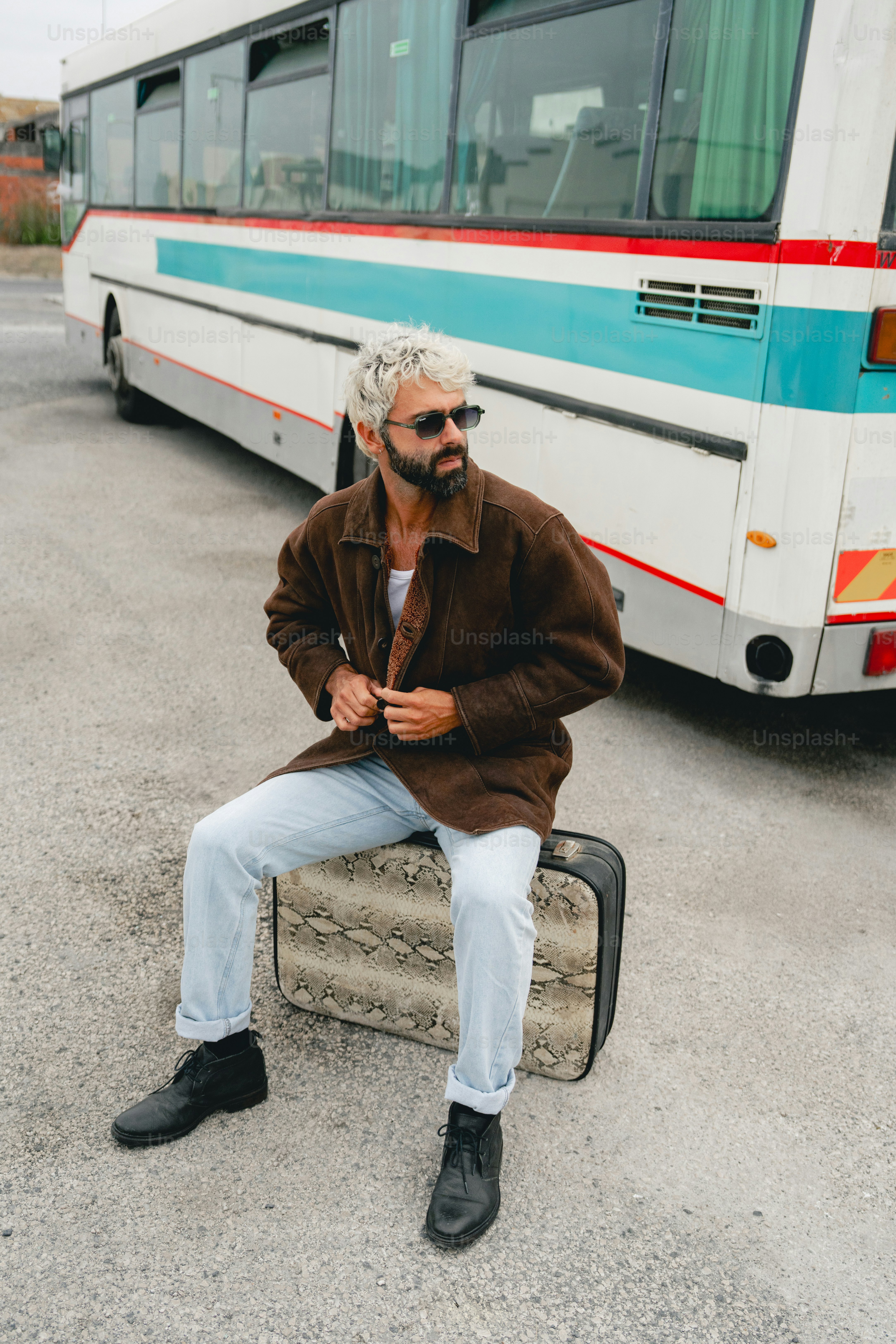 Man with suitcase stands by a bus photo – Travel Image on Unsplash