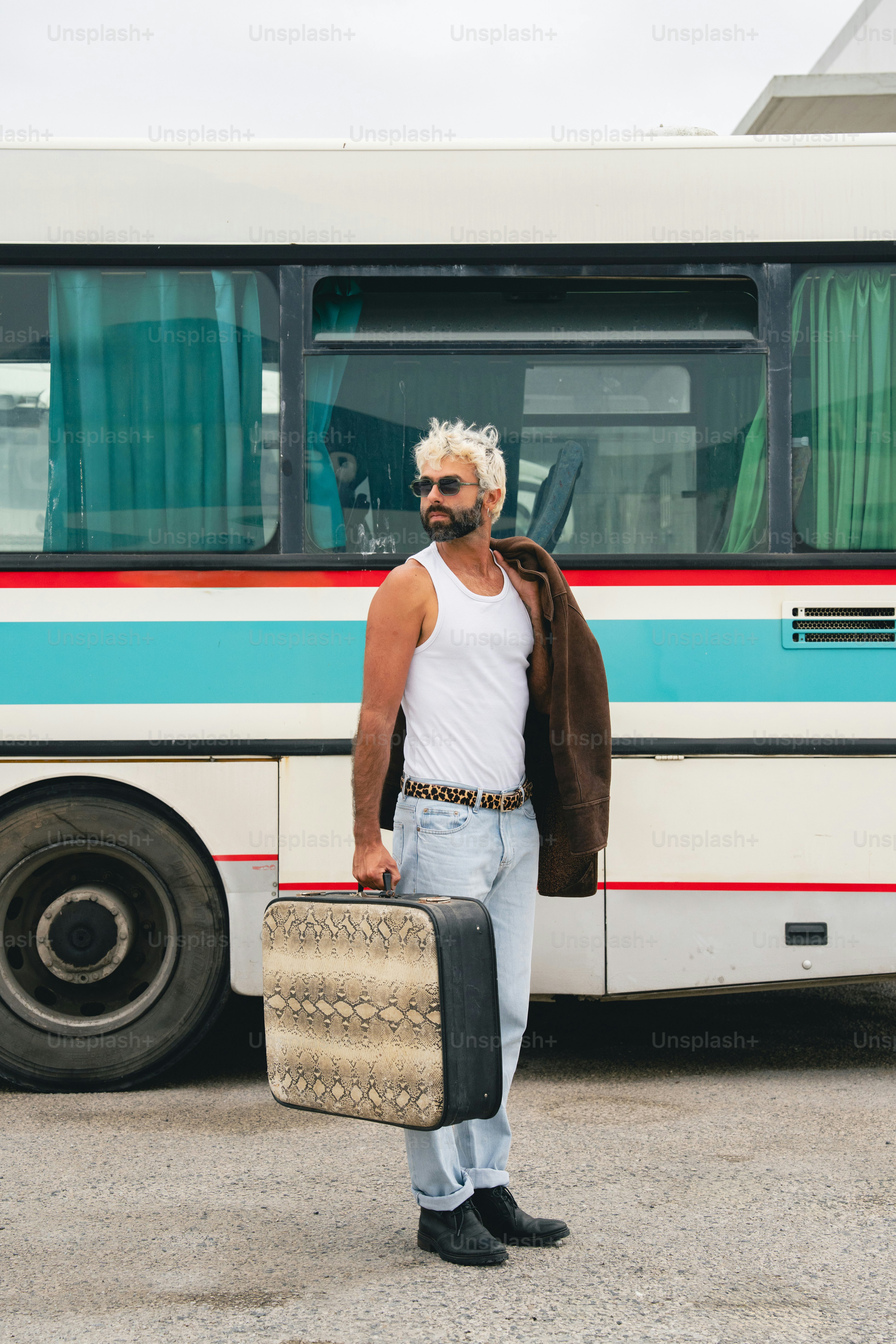 Man with suitcase stands by a bus photo – Travel Image on Unsplash