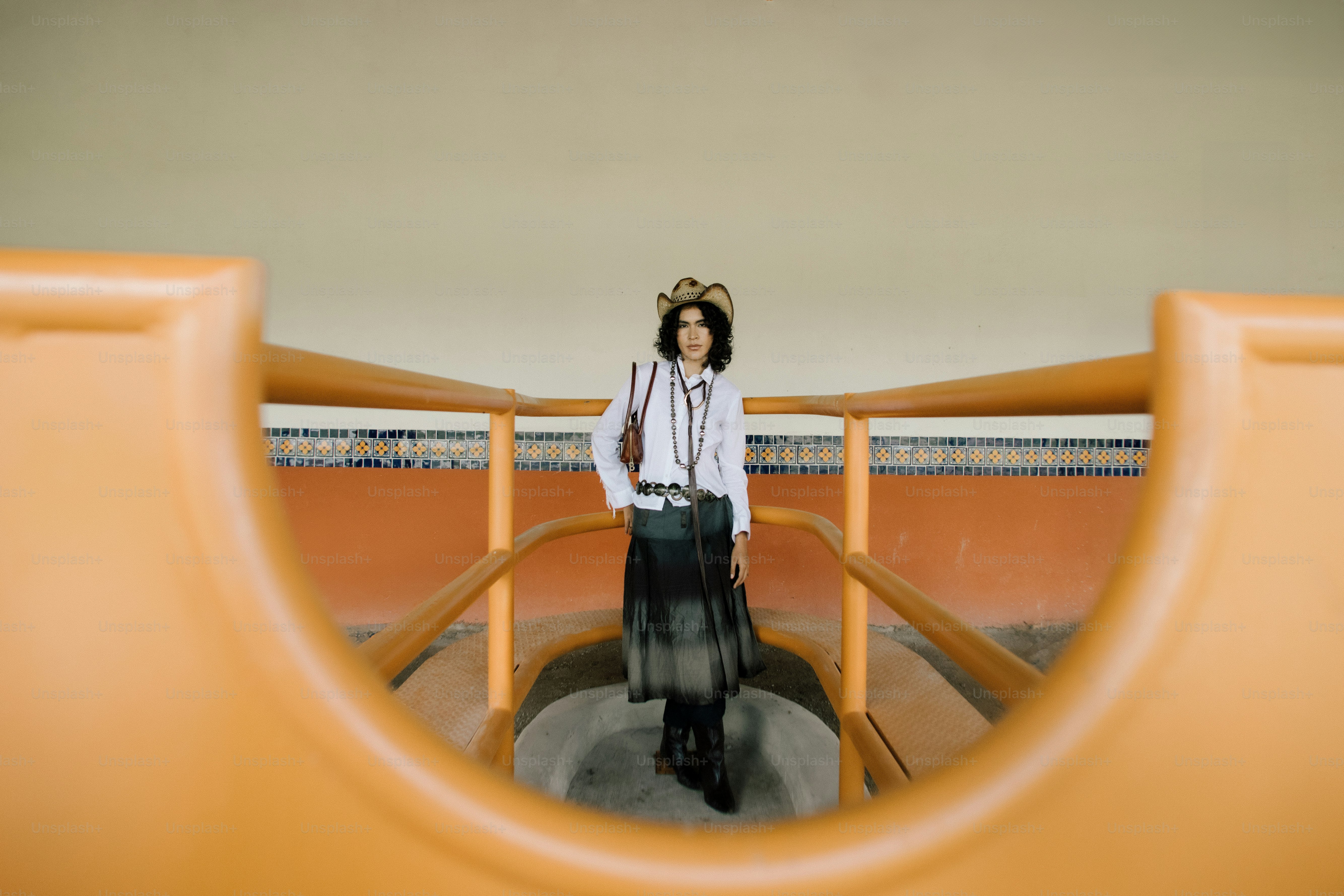 Woman wearing a crown and stylish outfit standing on stairs