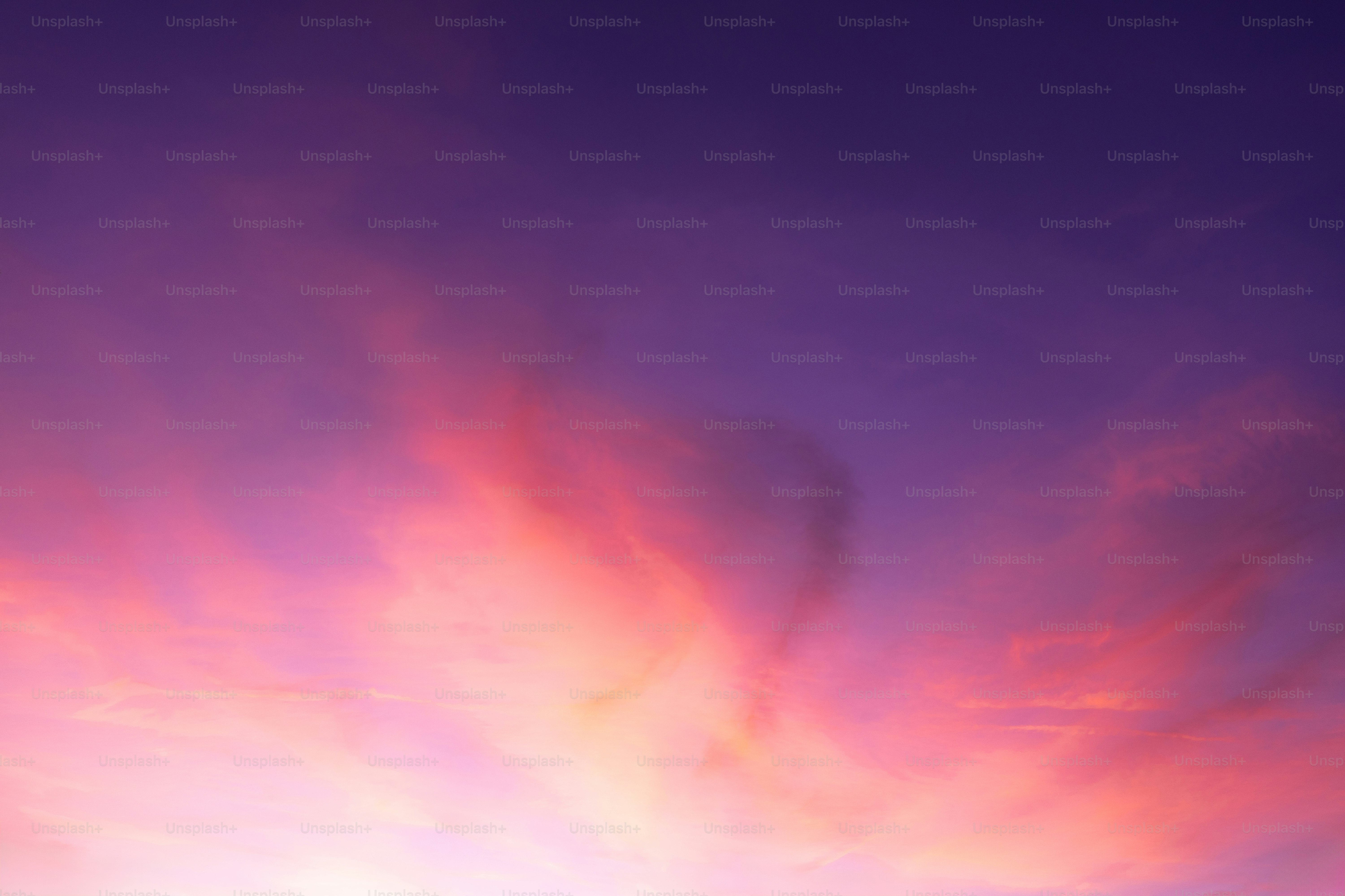 Vibrant clouds streak across a purple and pink sky.