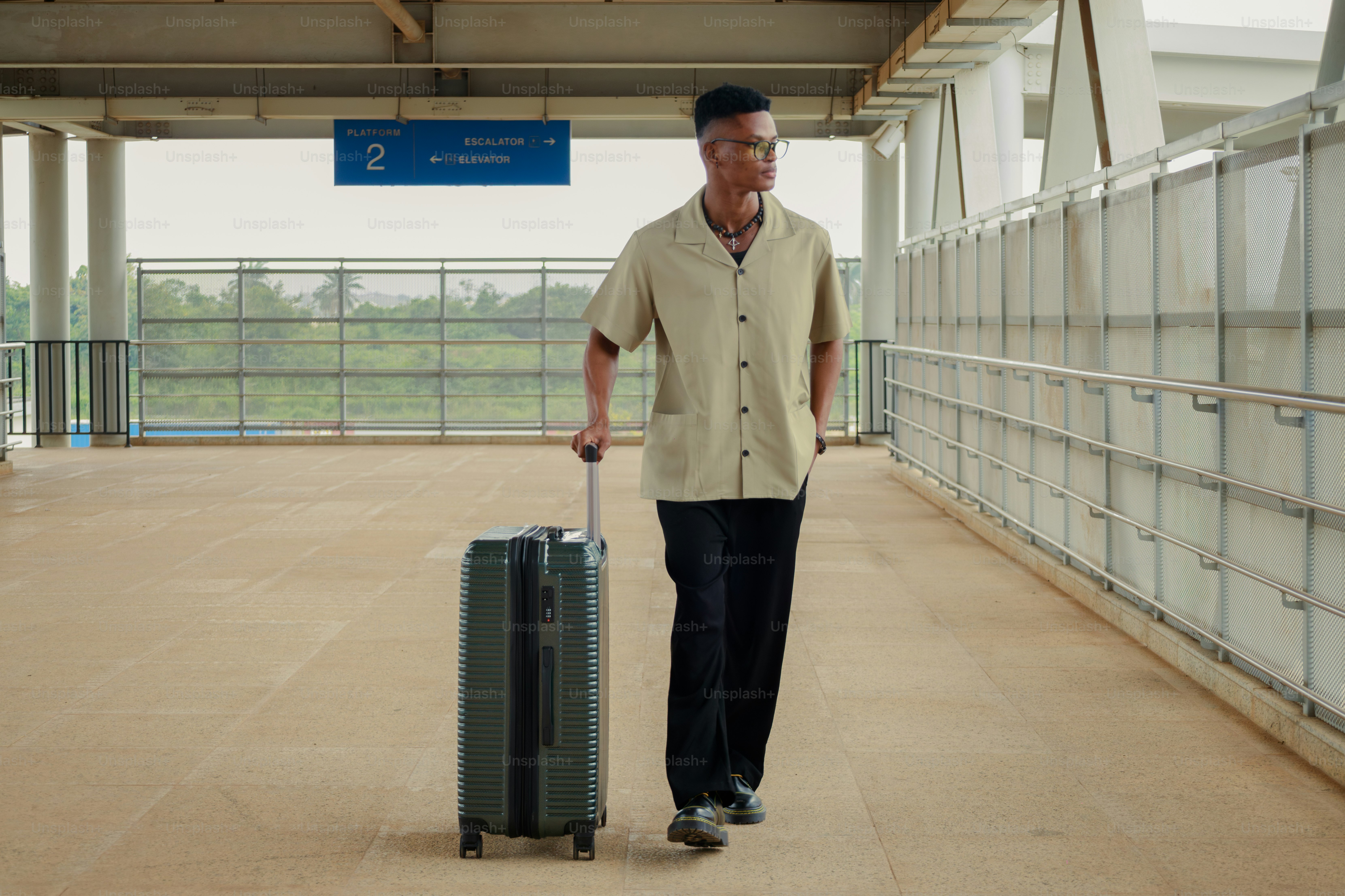 Man with suitcase walks on a platform.