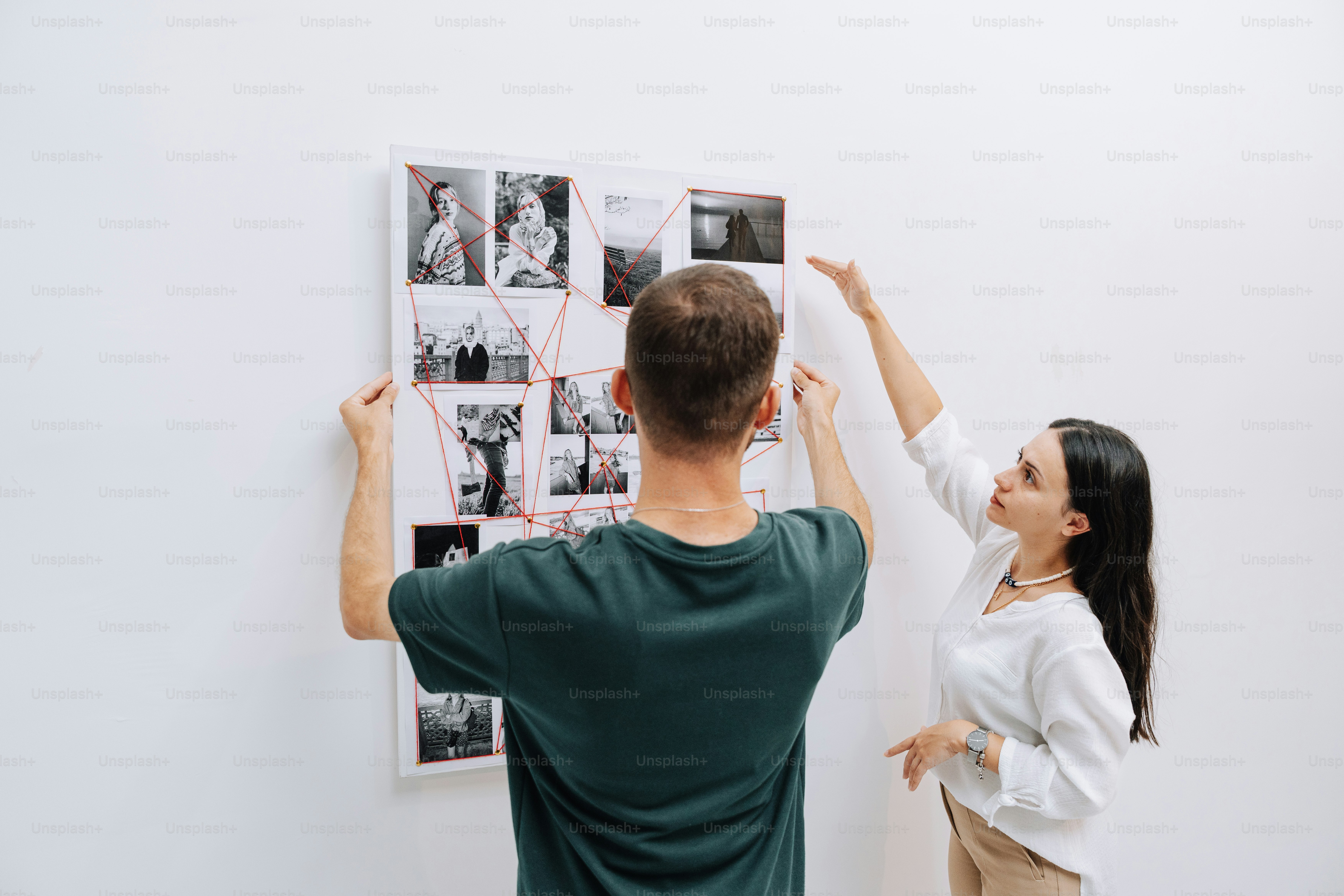 Two people observing artwork in a modern gallery. photo – Art Image on ...