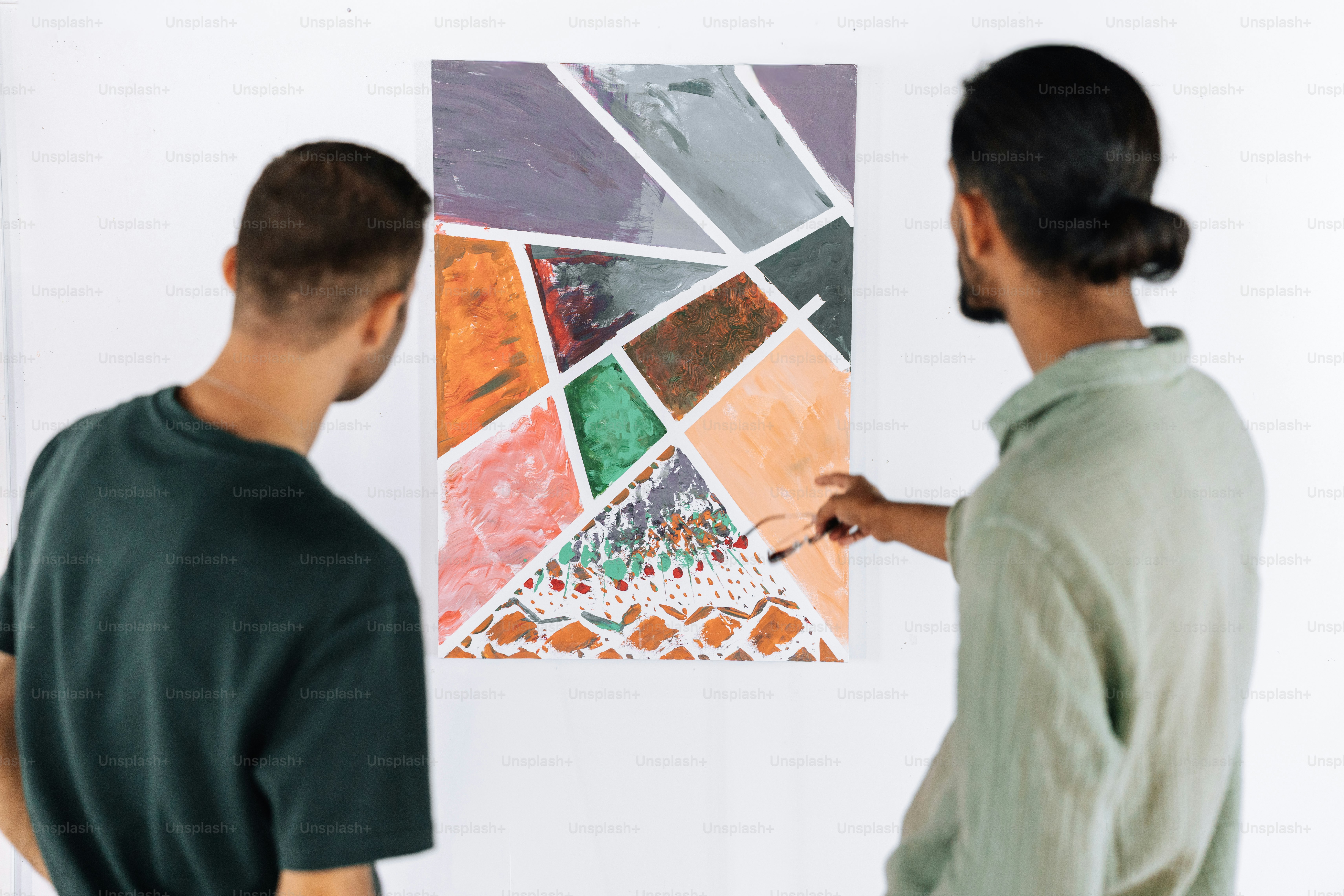Two people observing artwork in a modern gallery. photo – Art Image on ...
