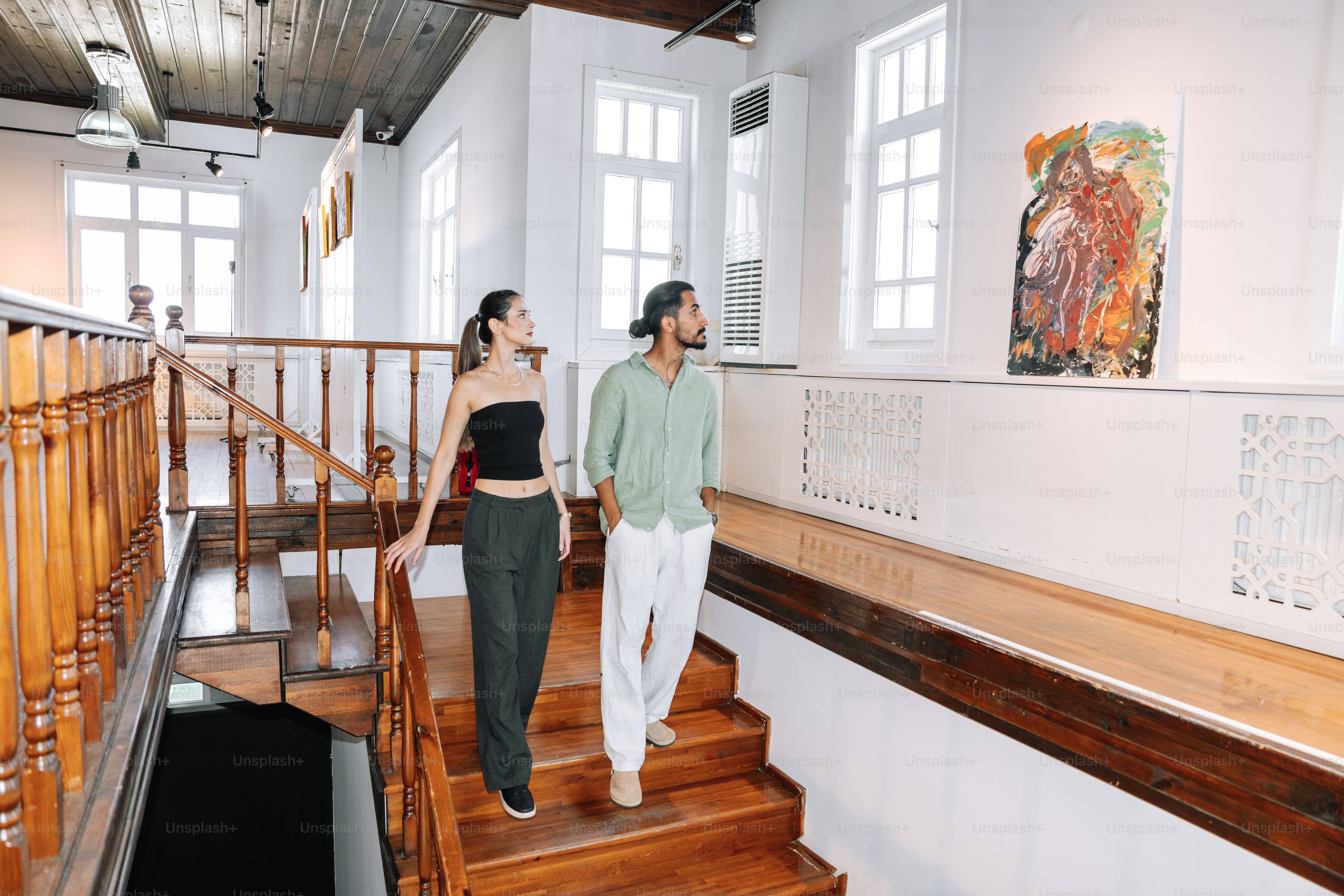 Couple looking at artwork on gallery wall