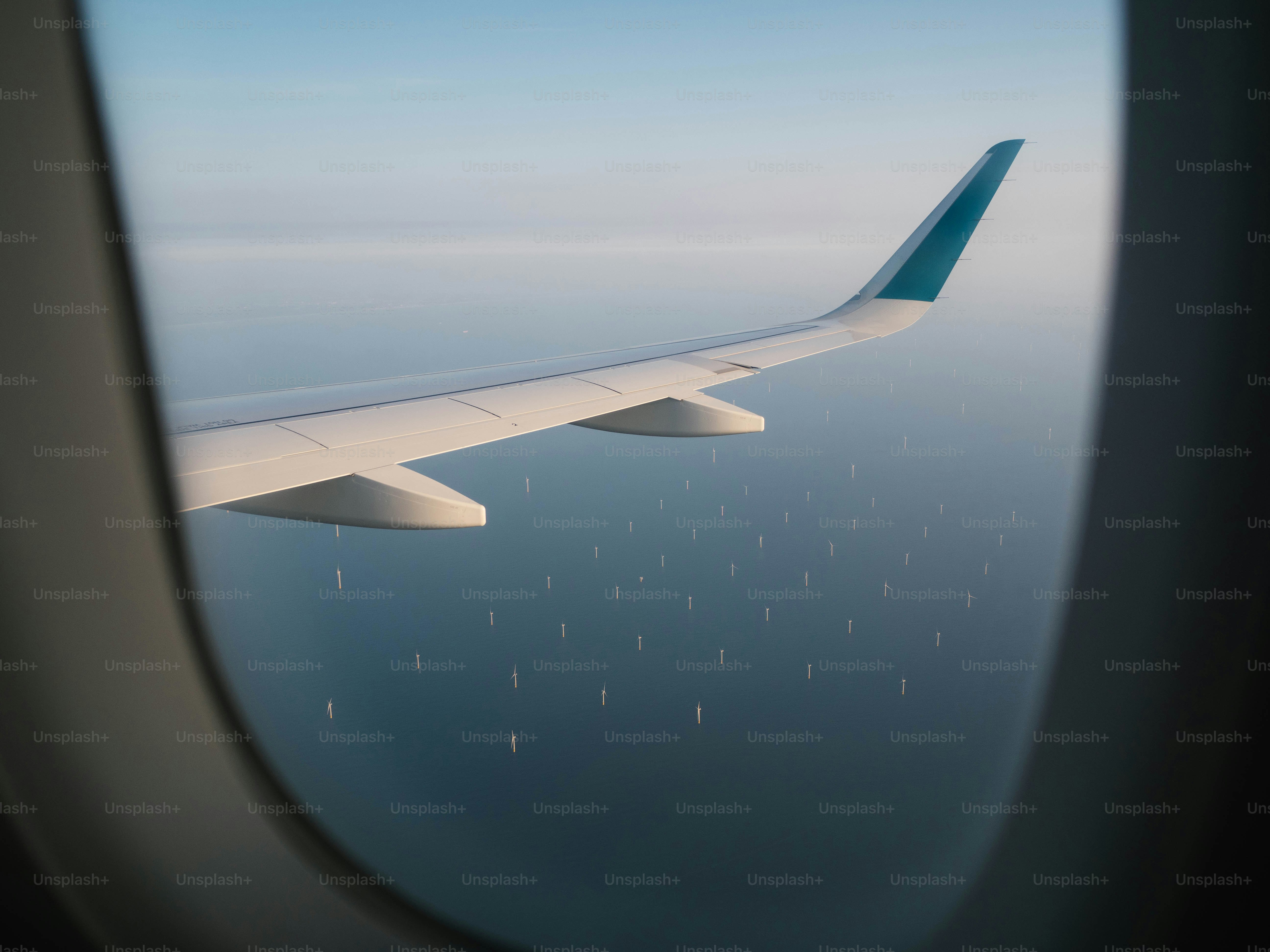 Airplane wing over offshore wind farm
