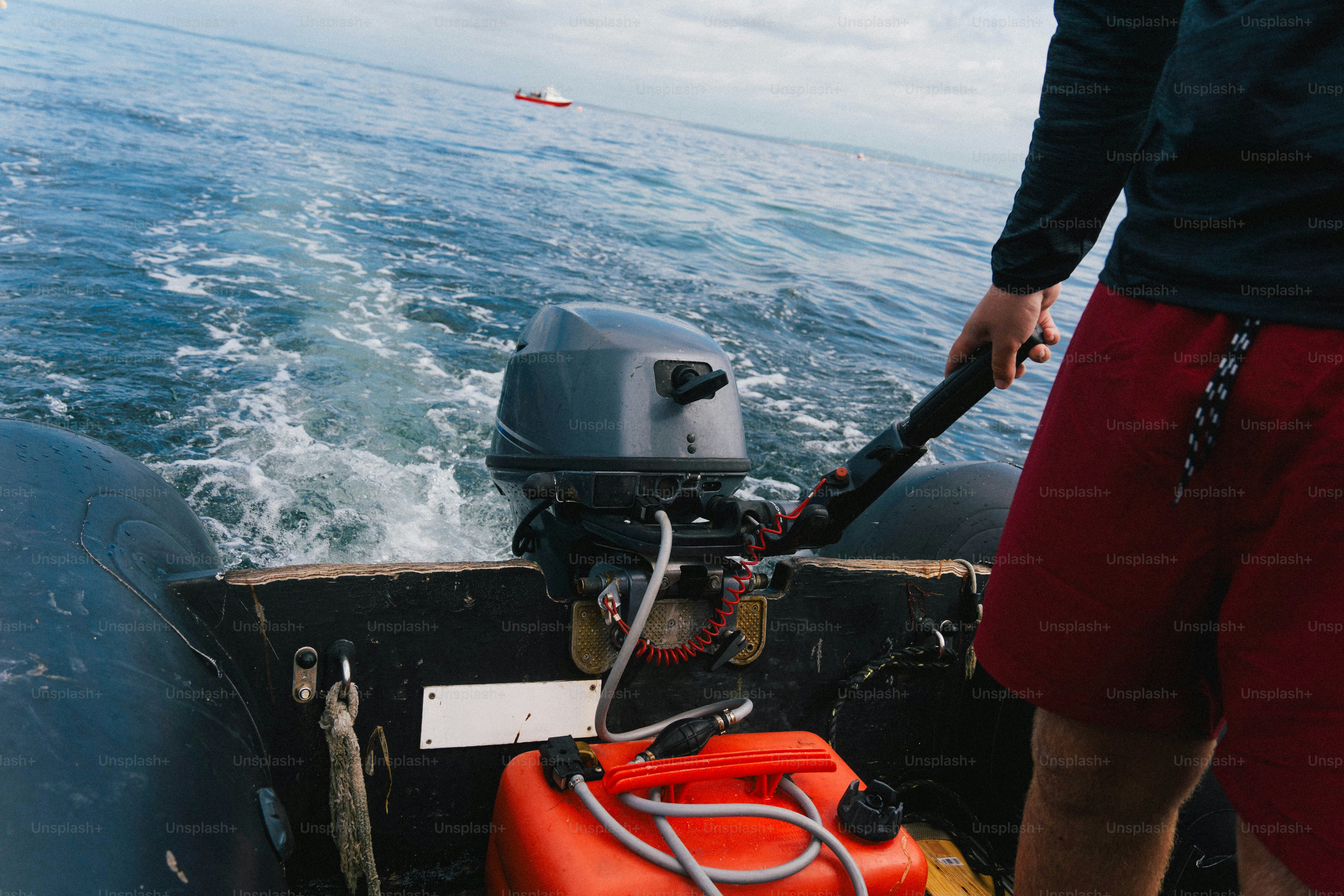 Person driving inflatable boat with outboard motor