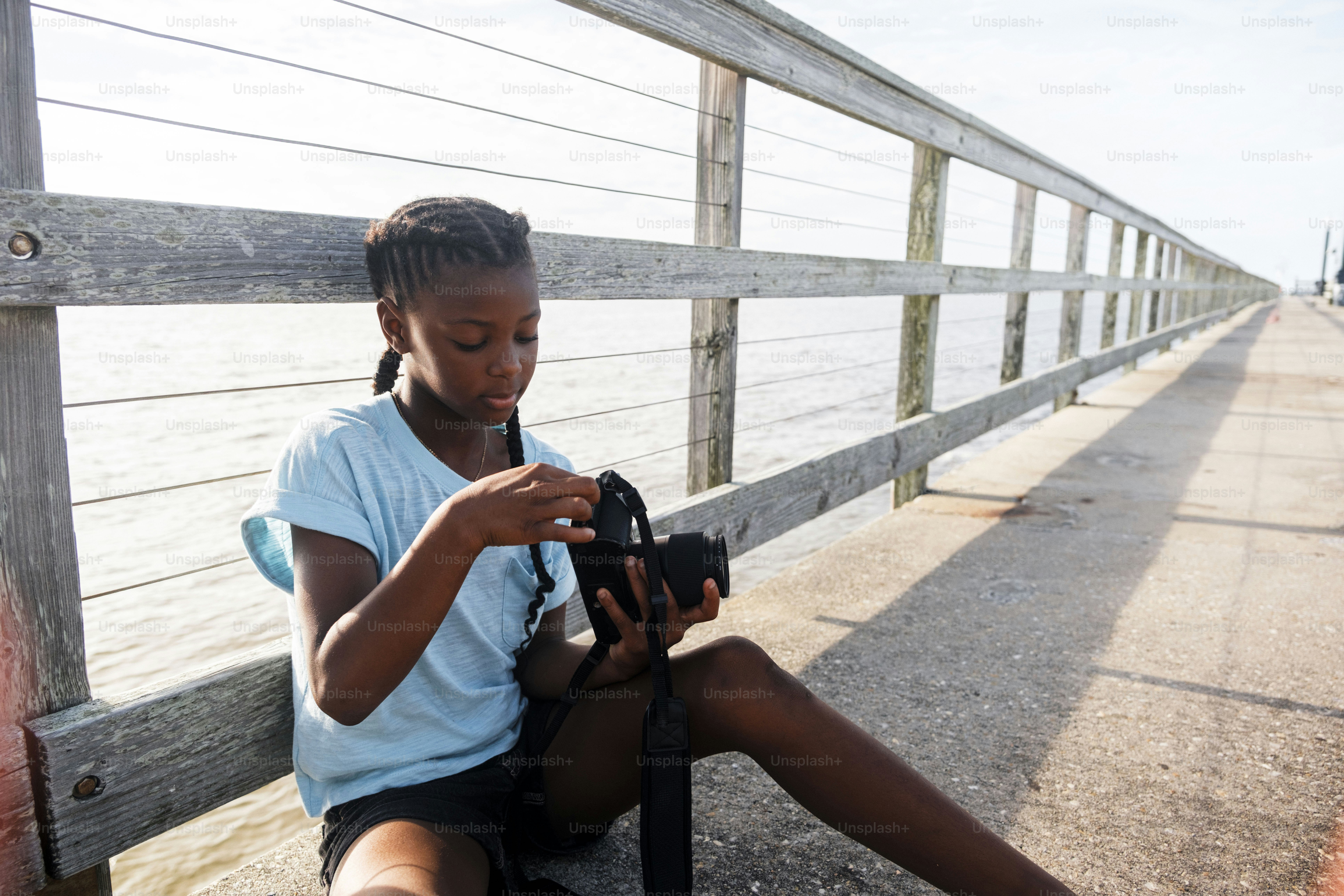 Young girl with headphones on pier