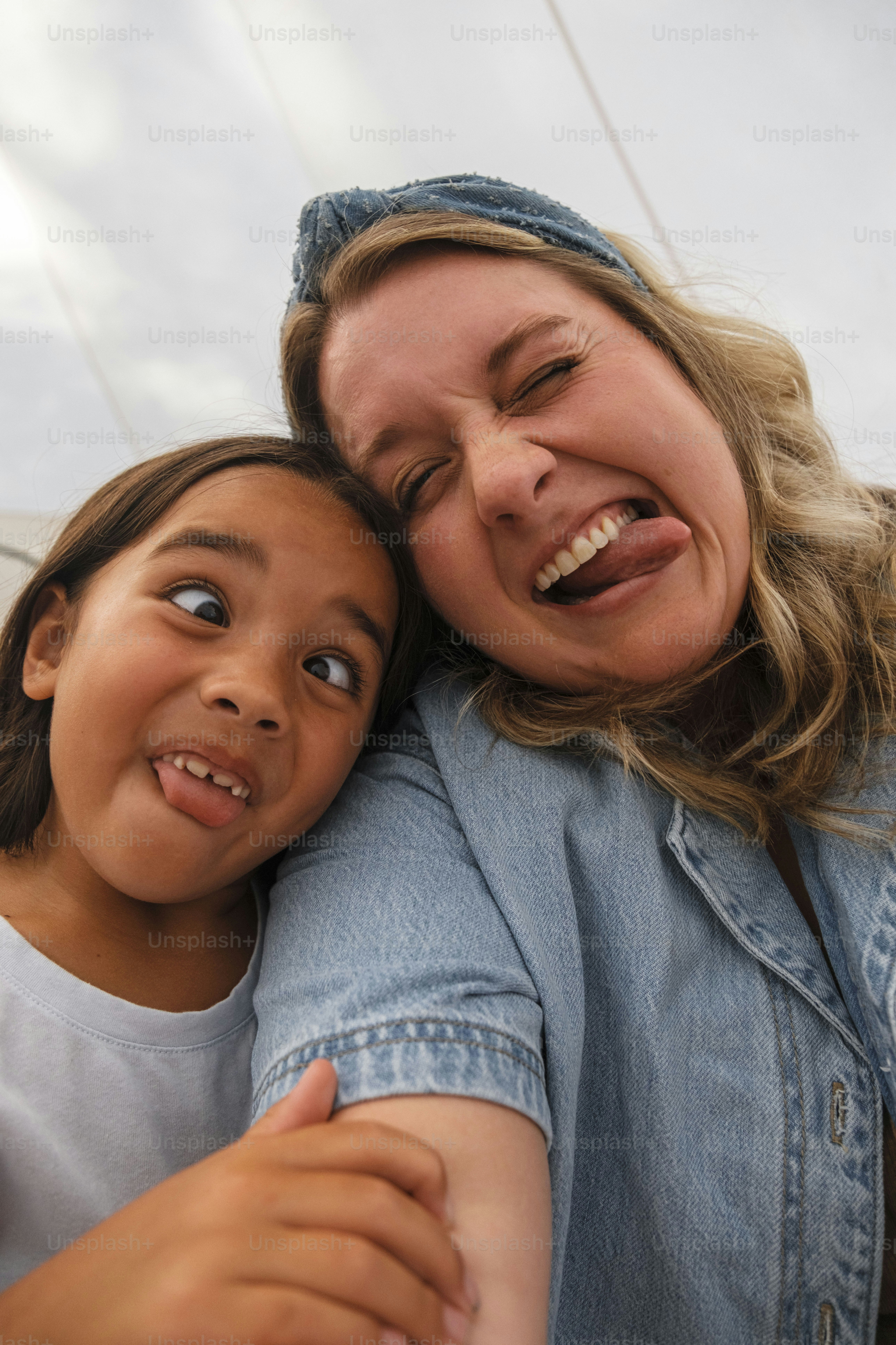 Woman and girl making silly faces together