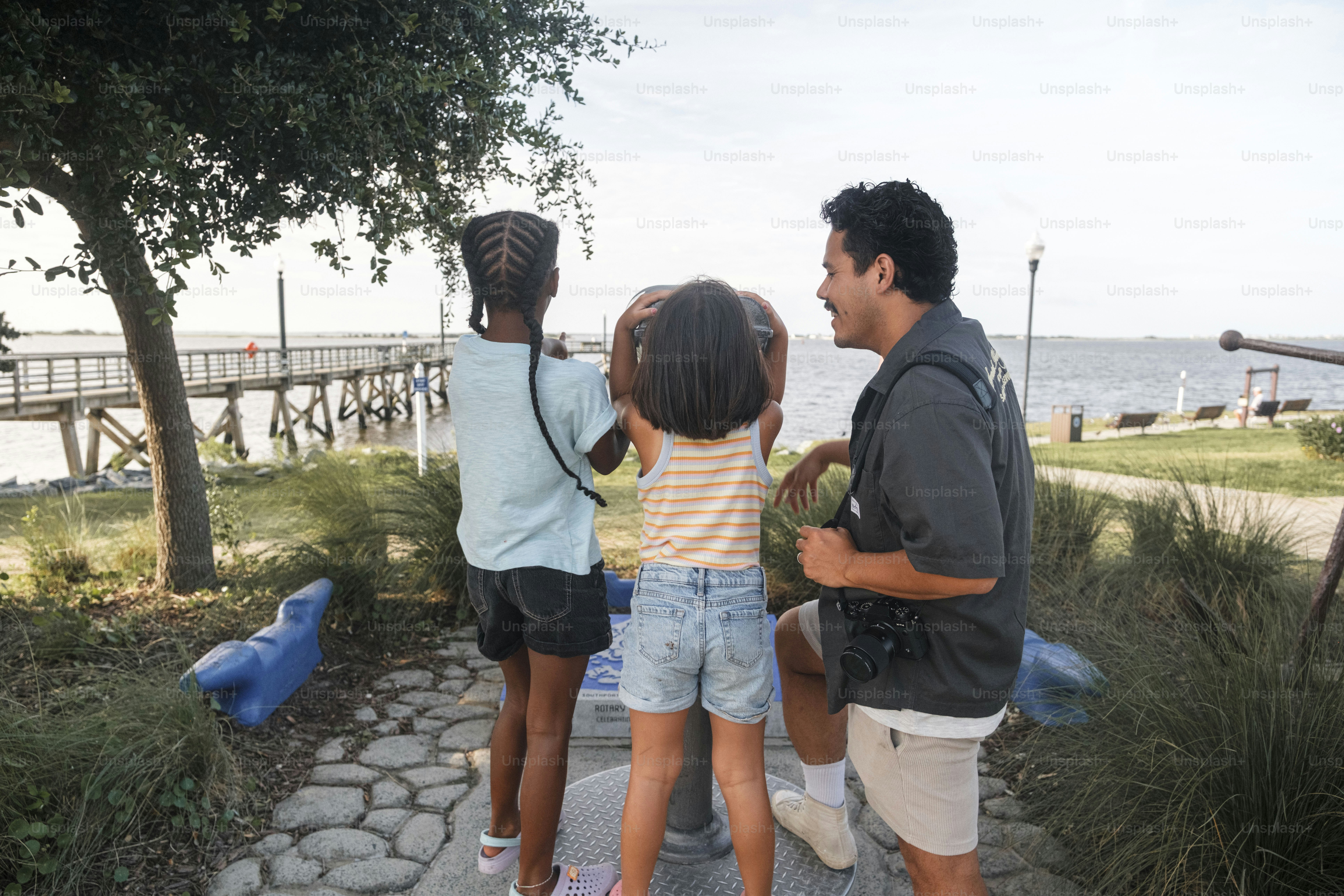Man and two children looking through telescope outdoors telescope outdoors telescope outdoors telescope outdoors telescope outdoors telescope outdoors telescope
