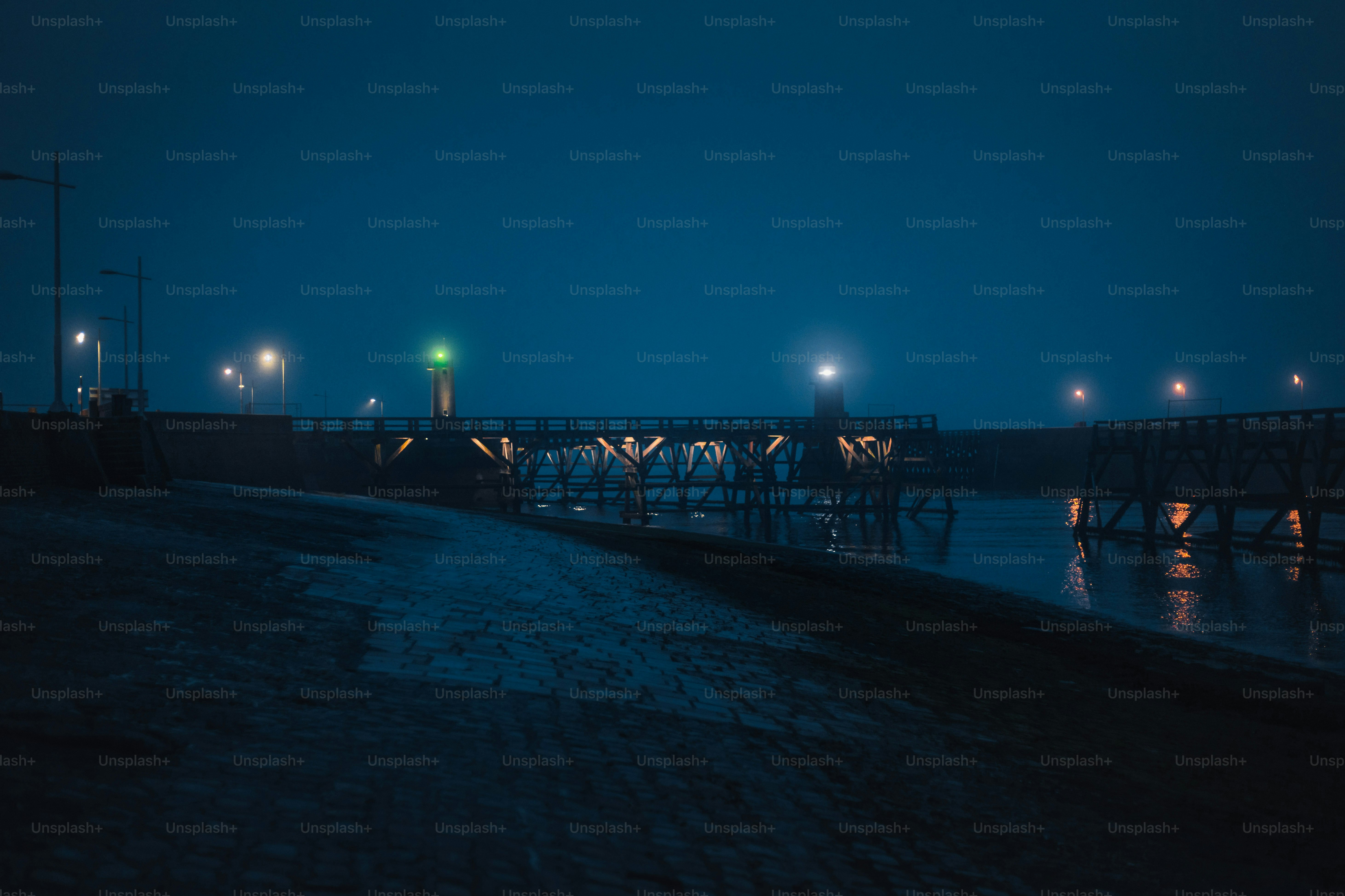 A bridge over water at night with lights.