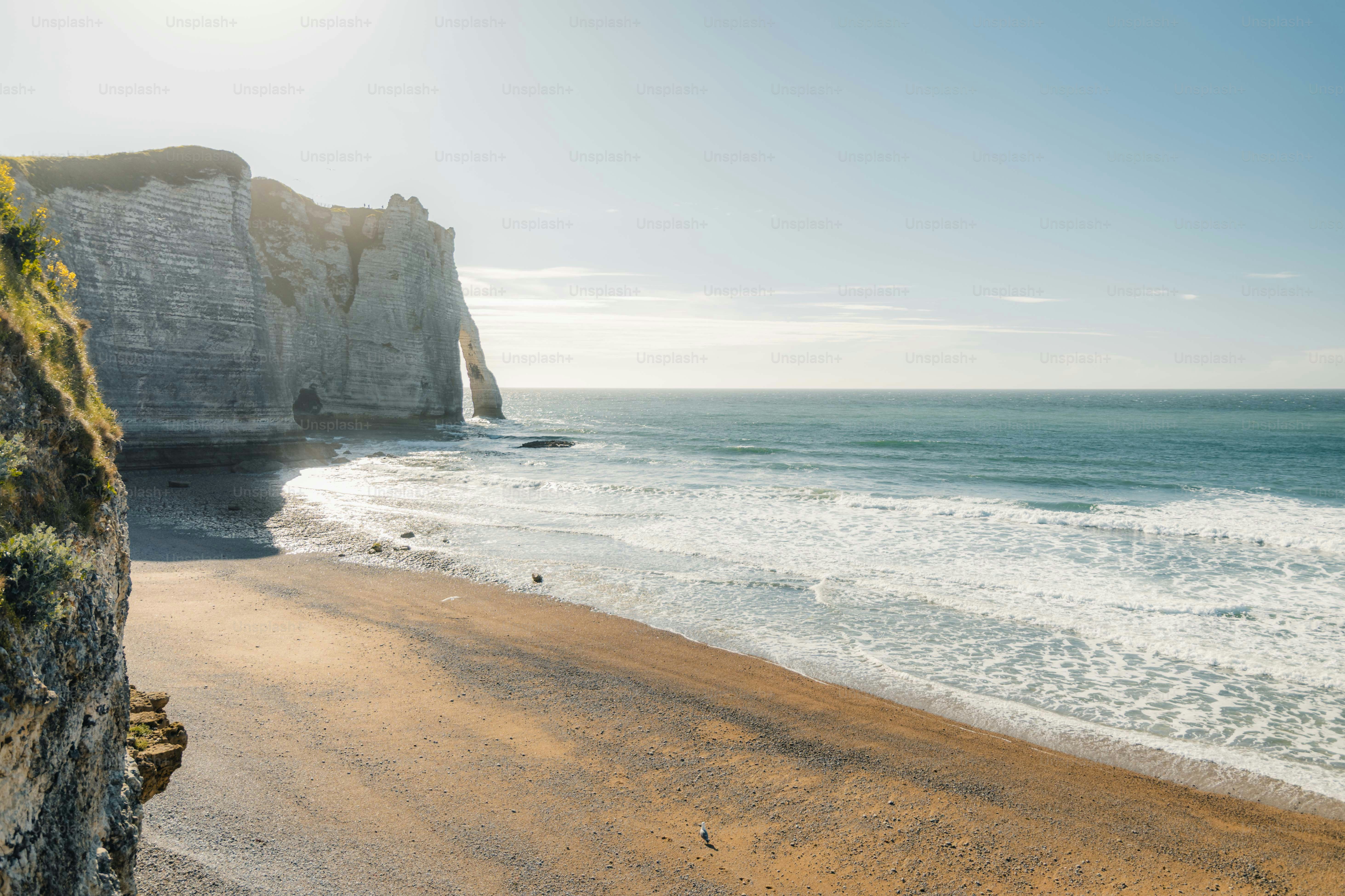 Sandy beach with cliffs and ocean waves