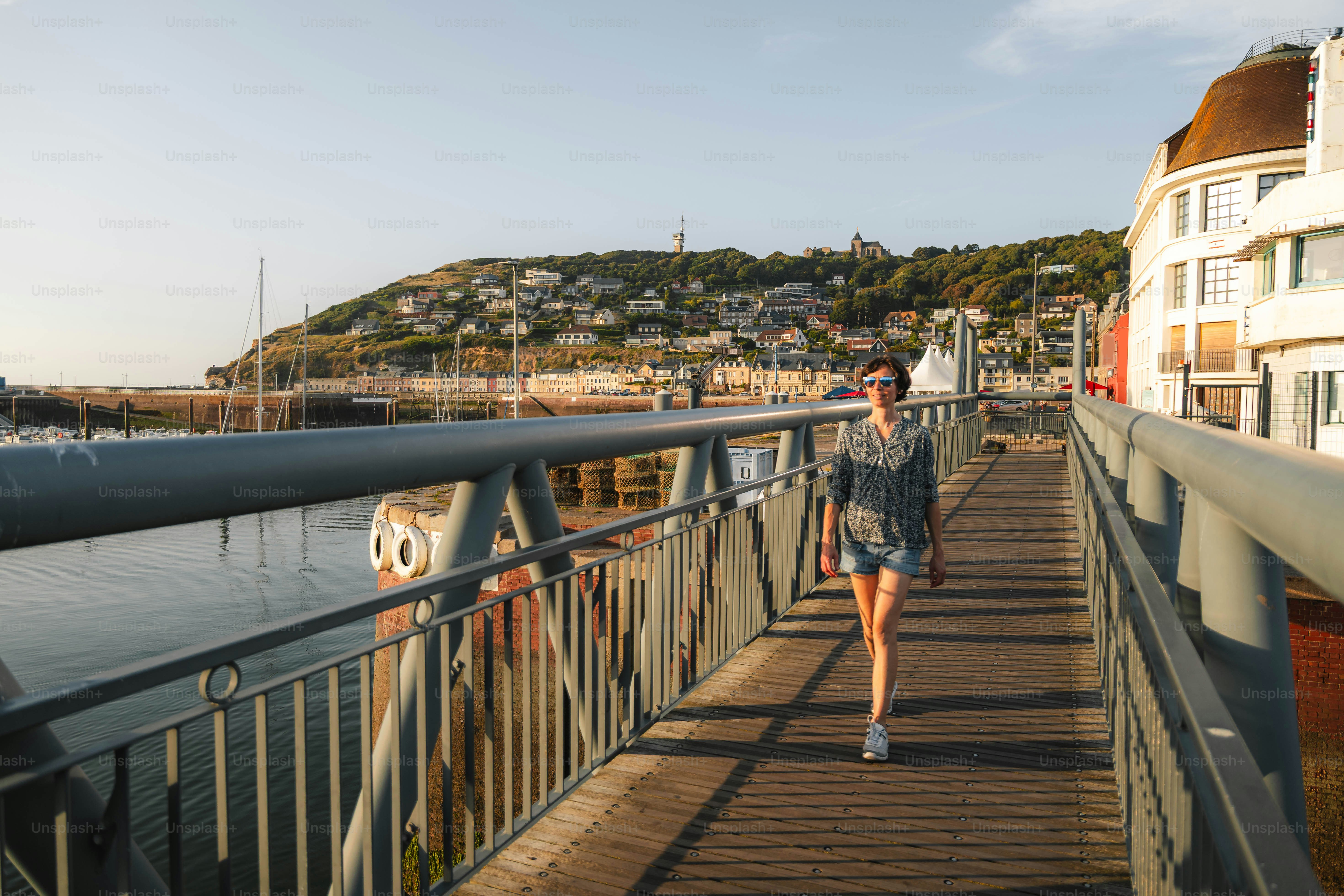 Woman walking on a bridge over water
