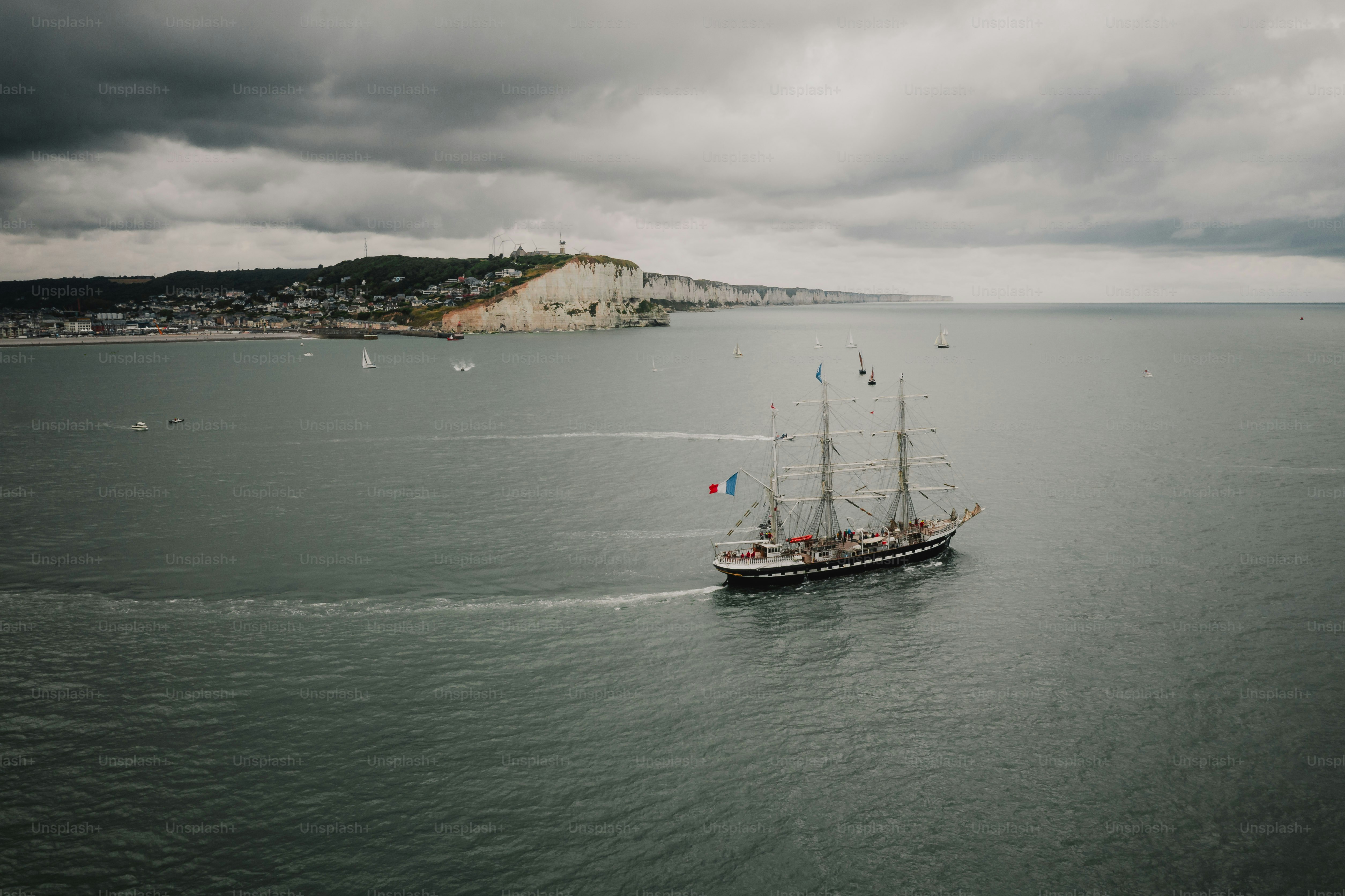 Tall ship sailing on the sea near coast