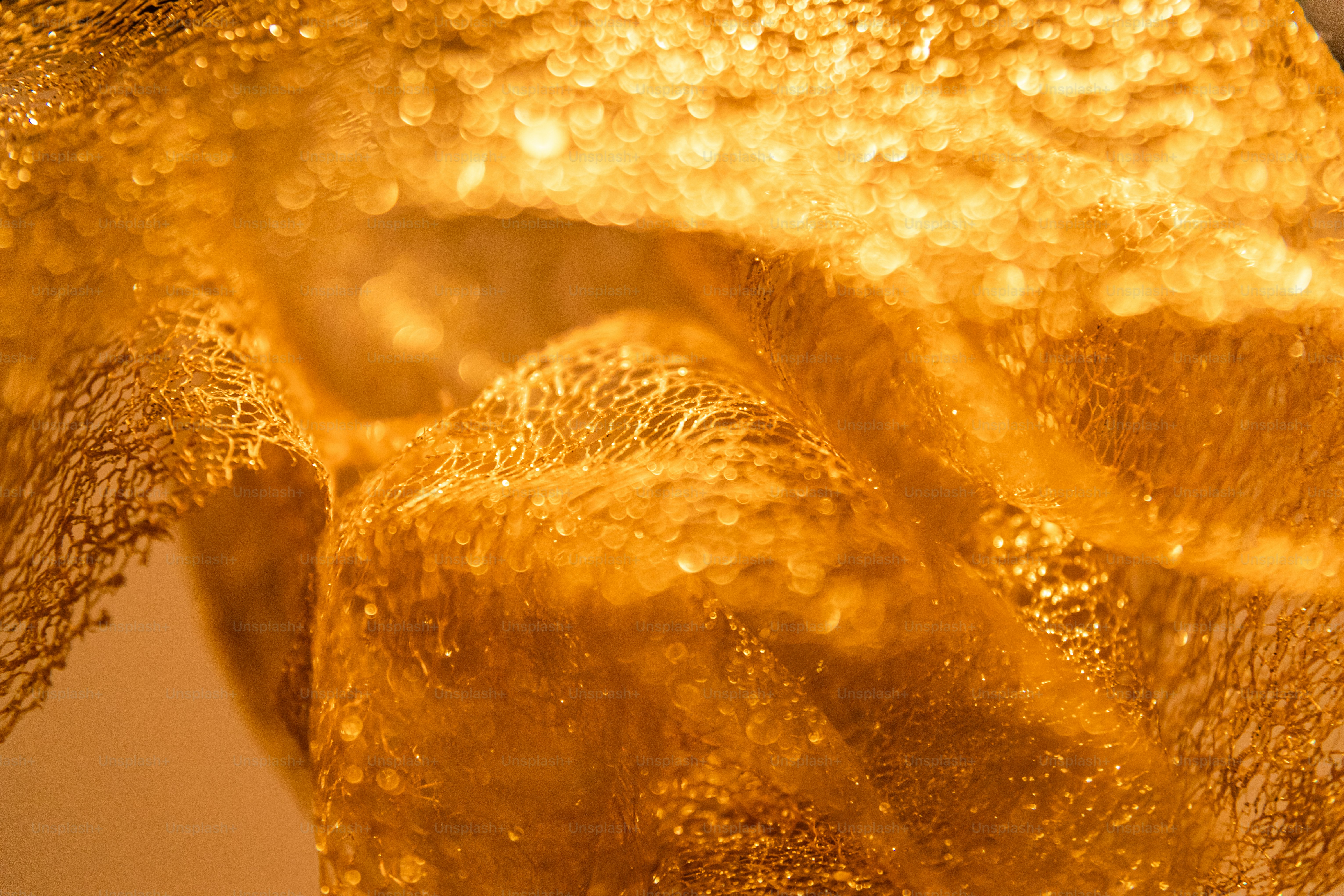 Close-up of textured golden fabric with sparkles