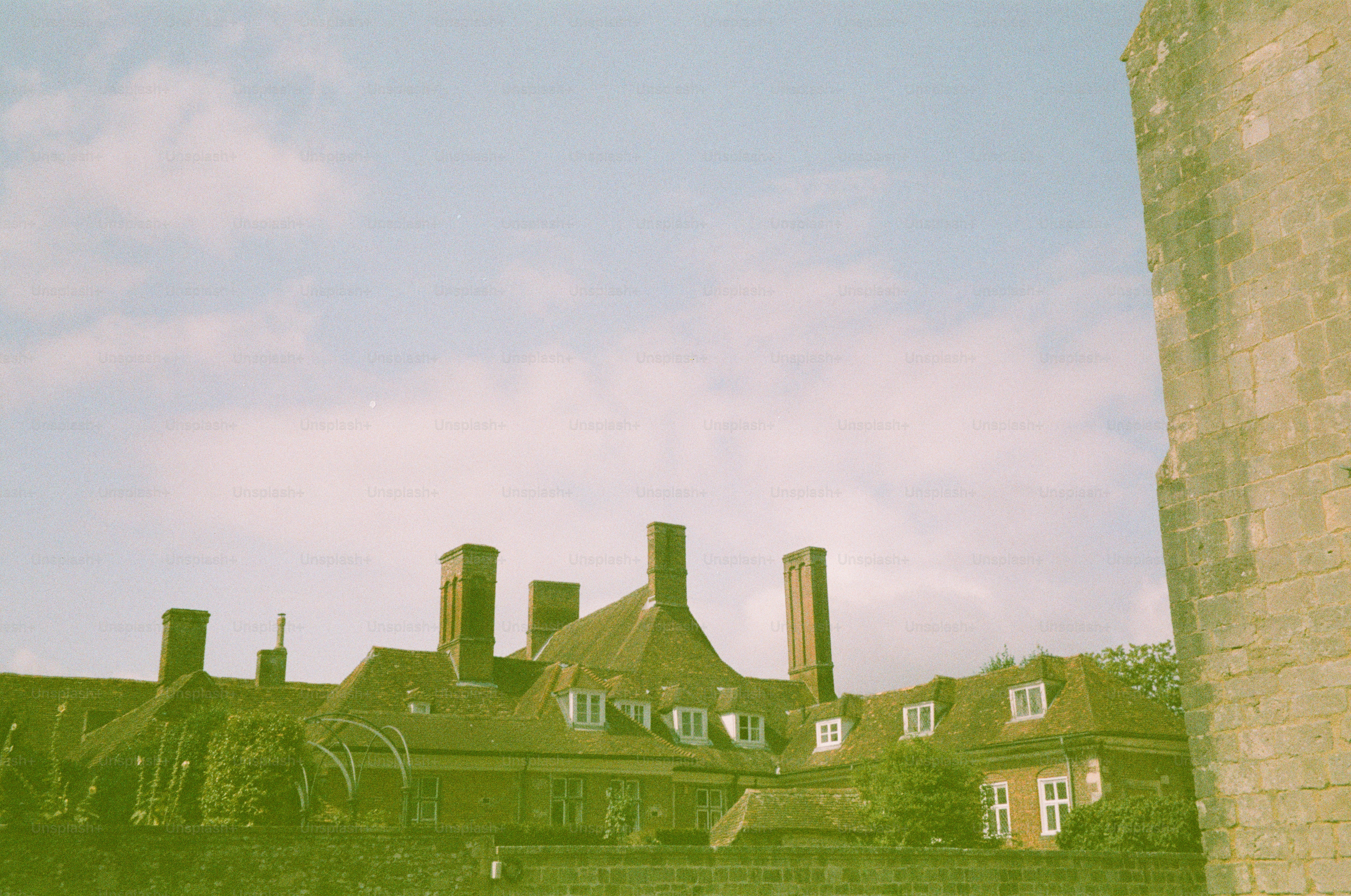 Historic building with chimneys against a cloudy sky photo ...