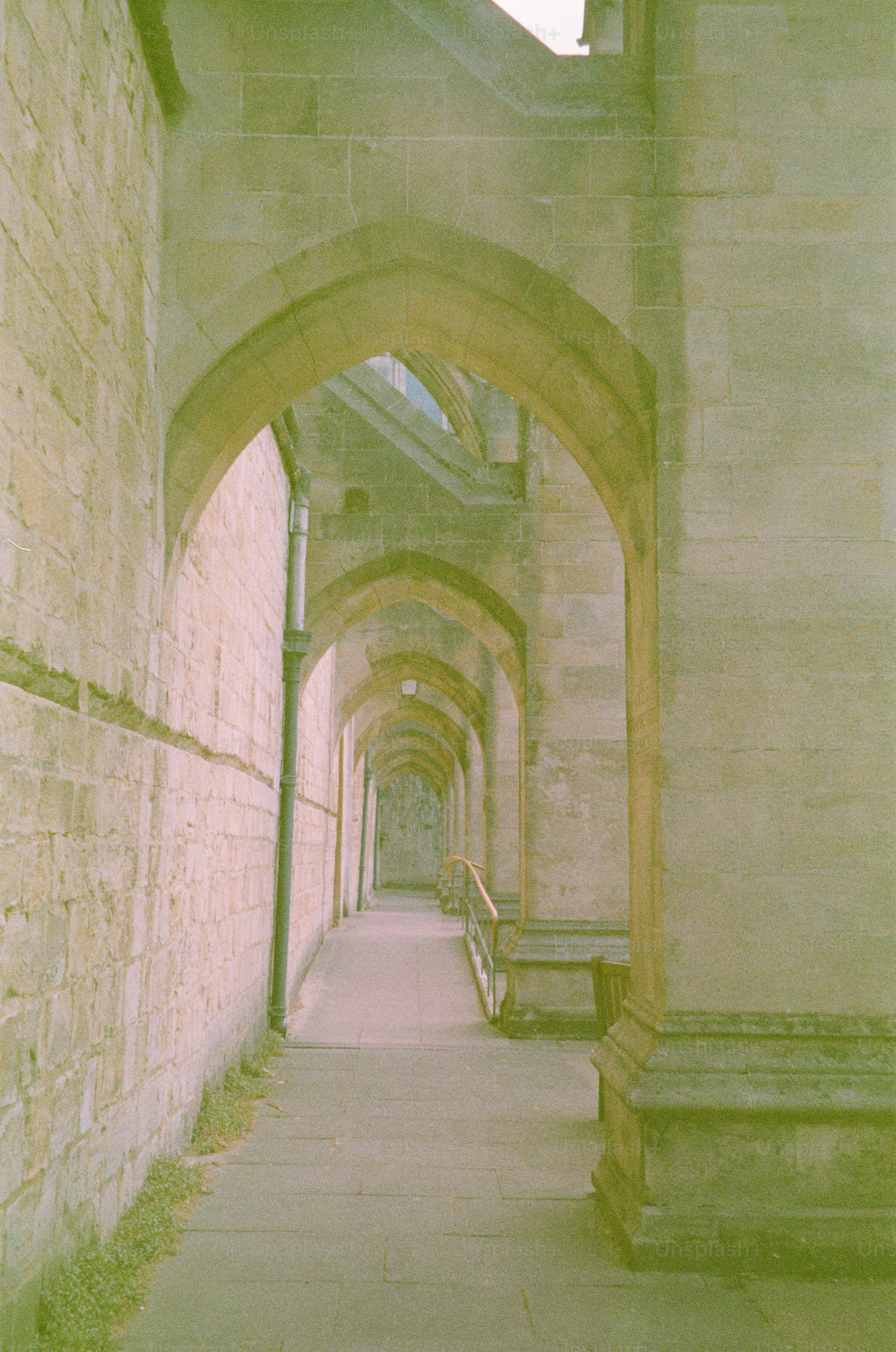 Stone arched walkway leading into the distance