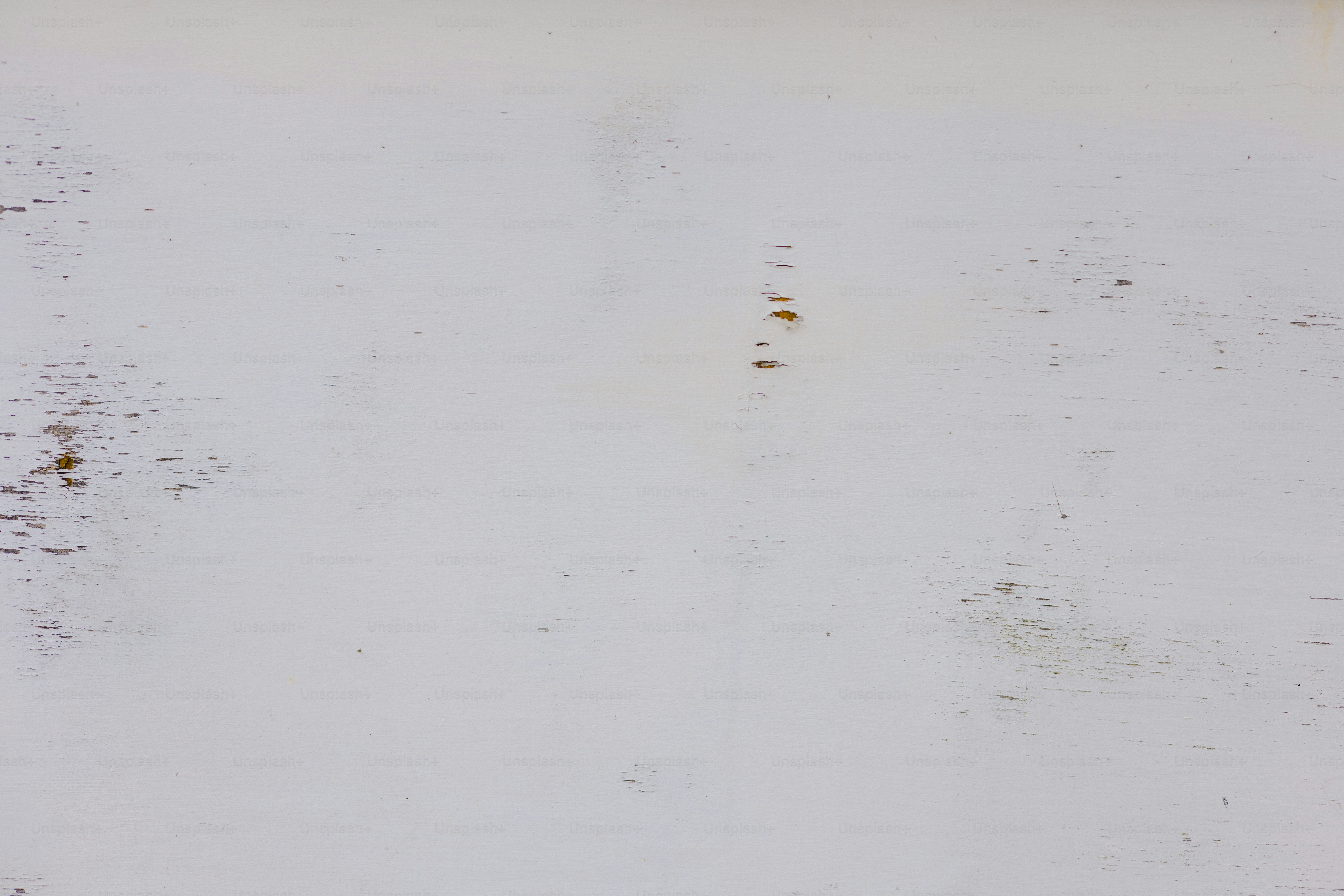 A white surface with small brown stains.