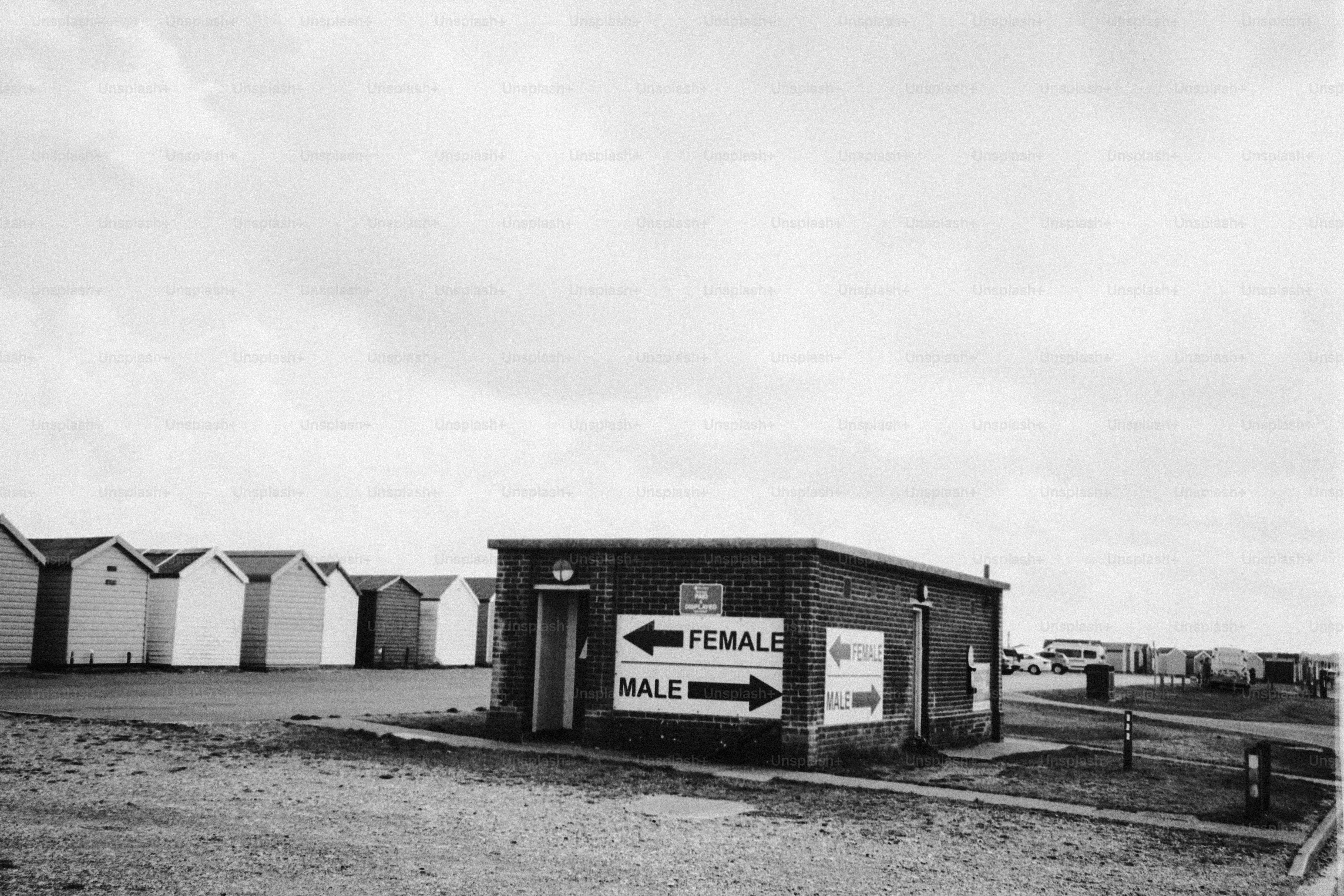 Public restroom building with male and female signs.