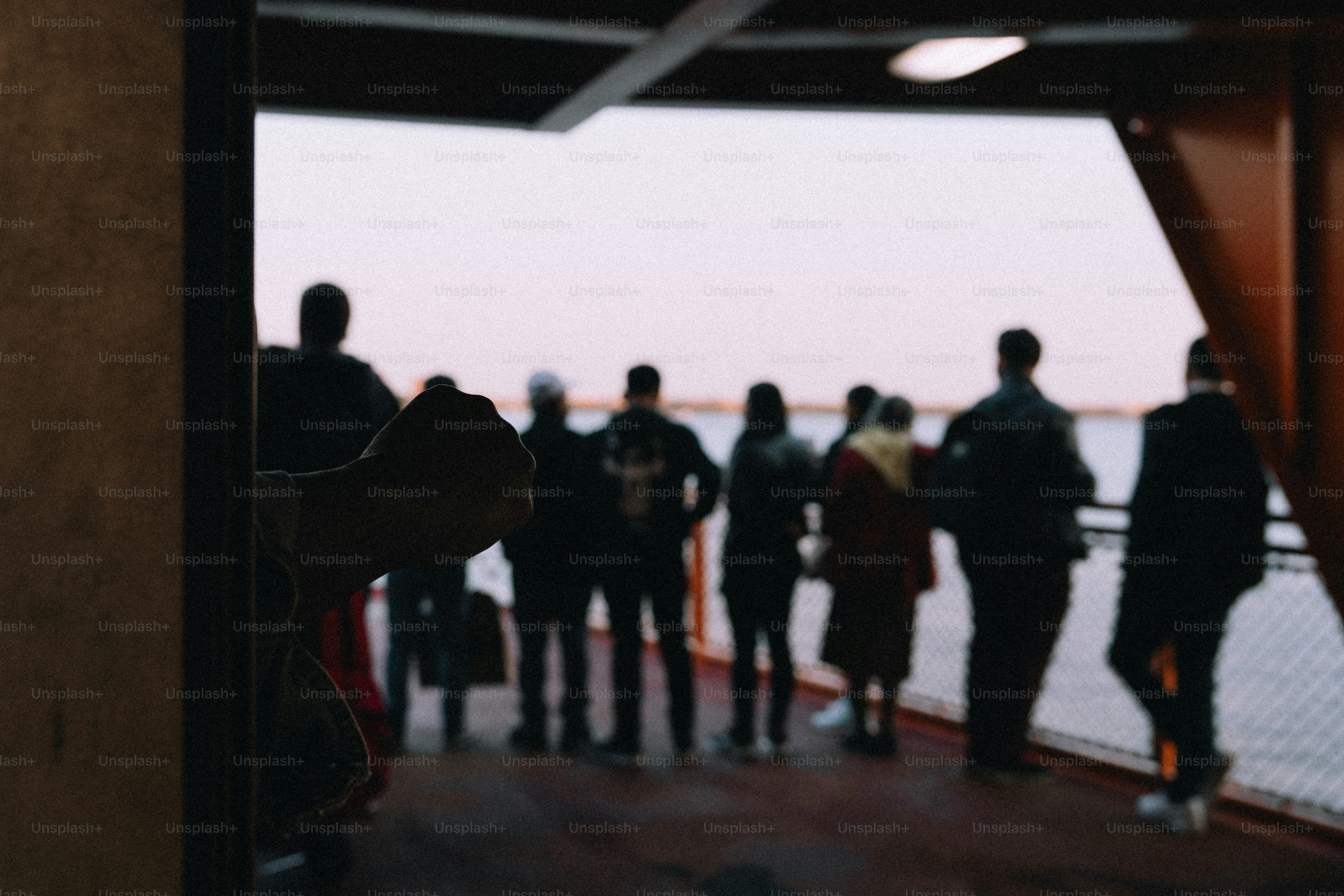 People silhouetted on a ferry at sunset
