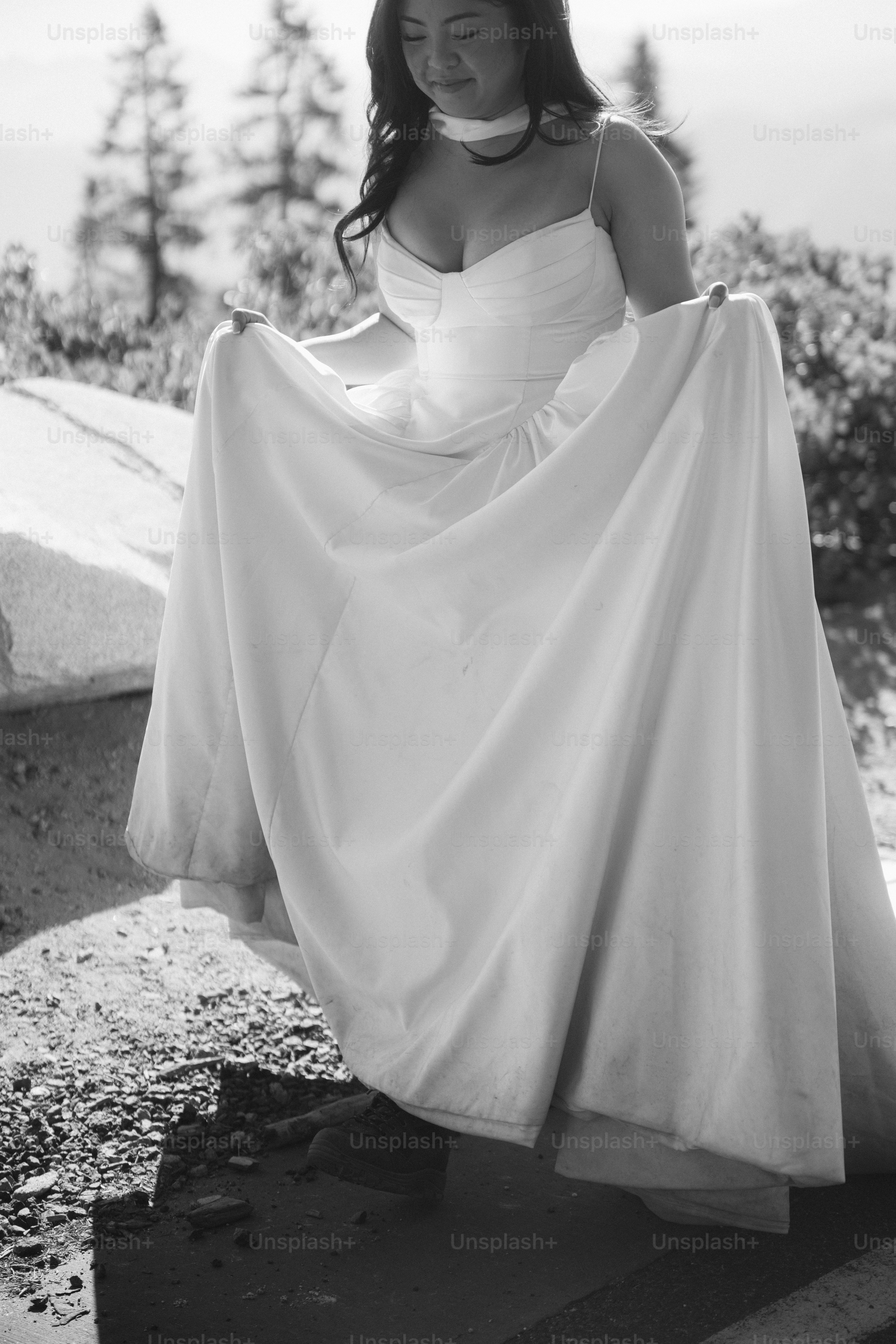 Bride in a white dress holding her skirt