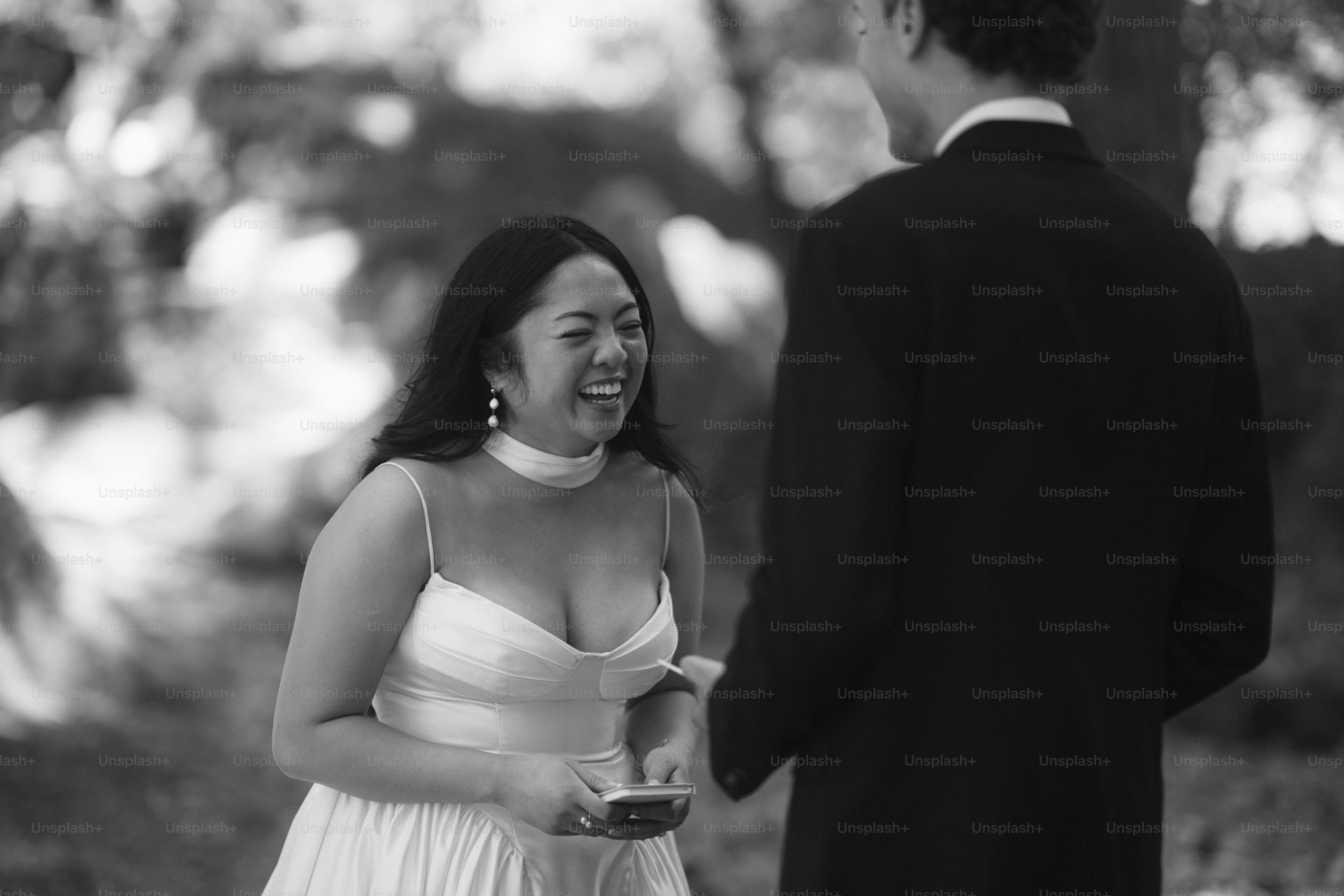Bride laughing with groom at outdoor wedding
