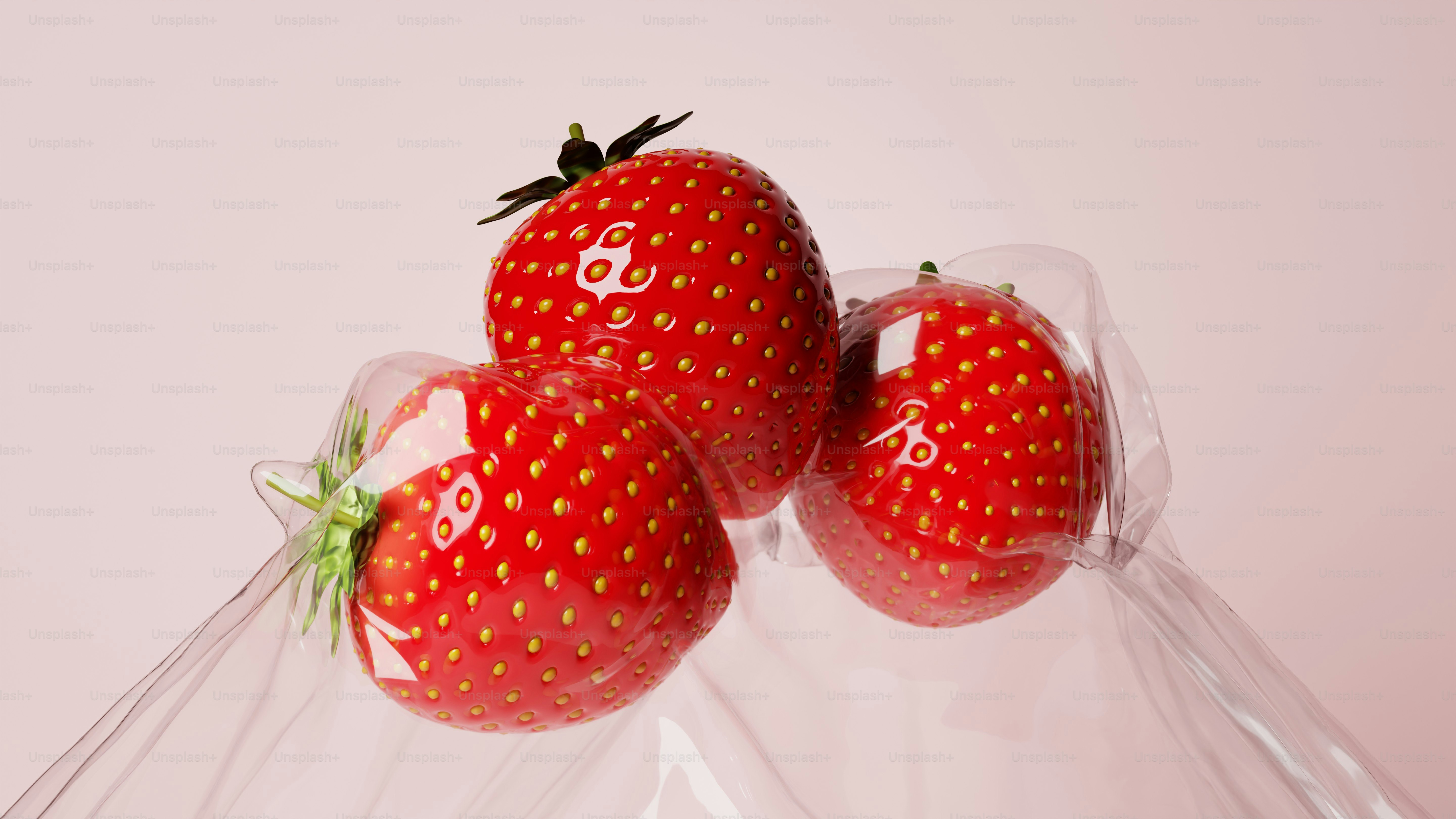 Three fresh strawberries in clear plastic packaging.