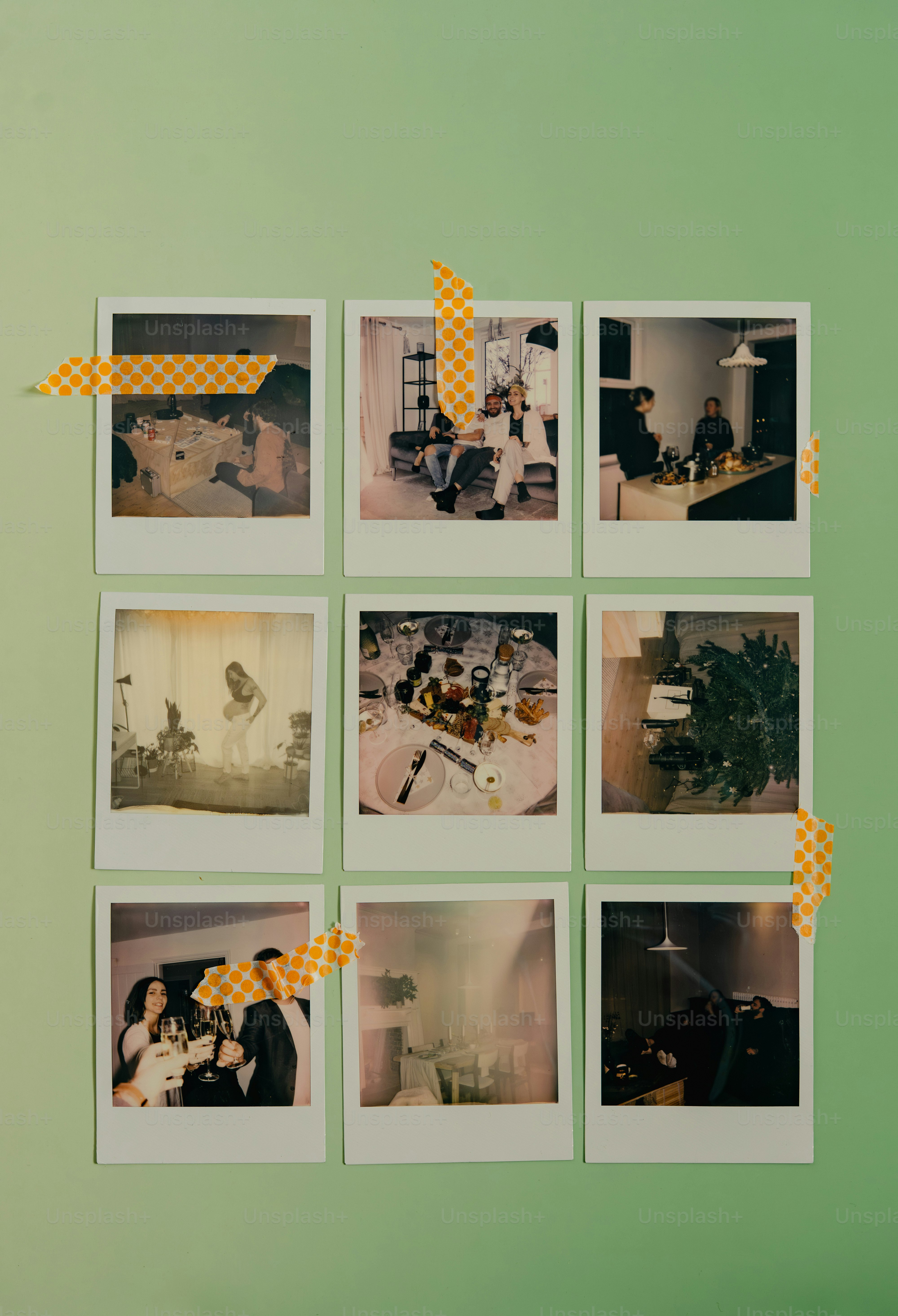 Nine instant photos taped to a green wall.