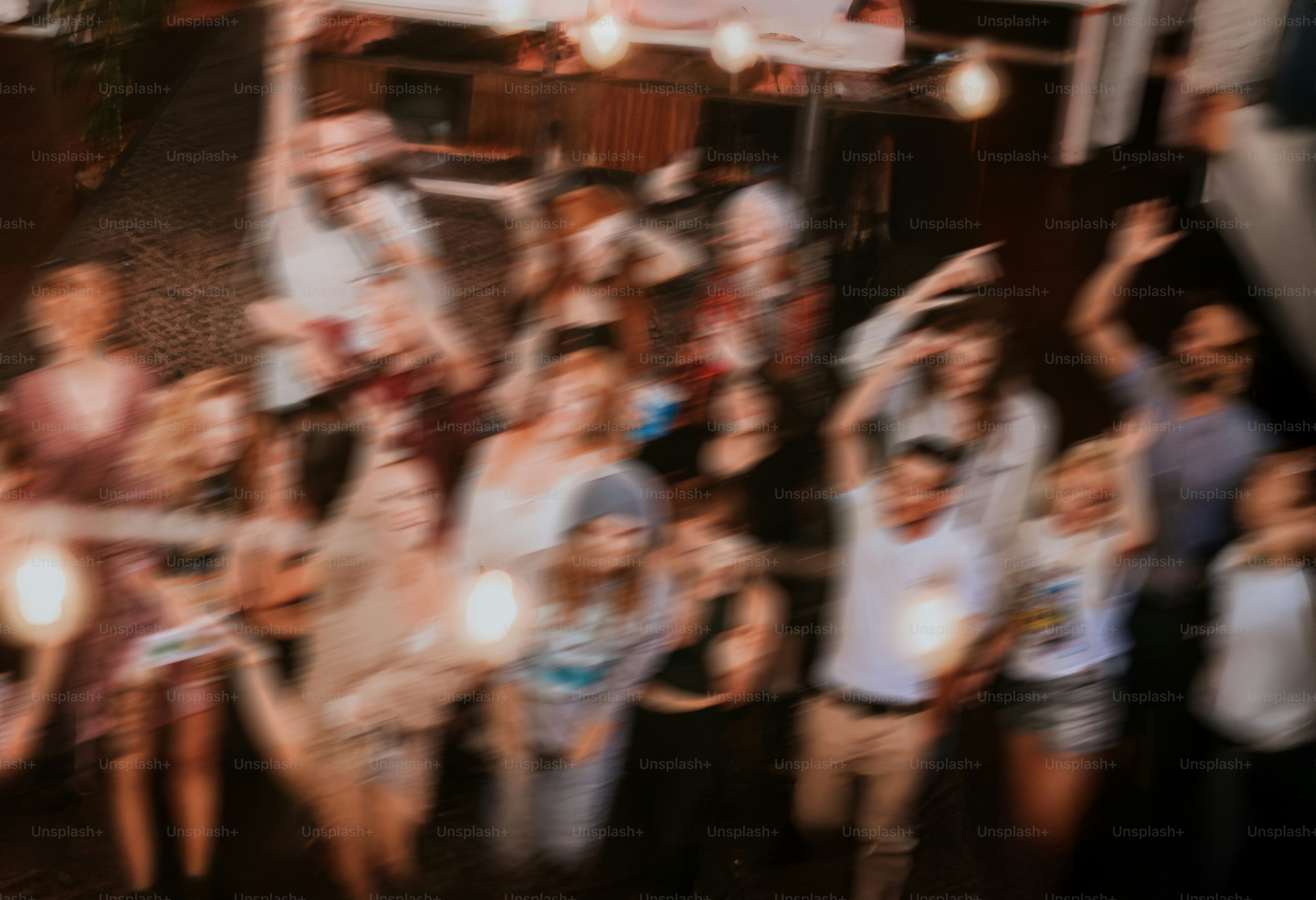 Group of people celebrating with raised hands