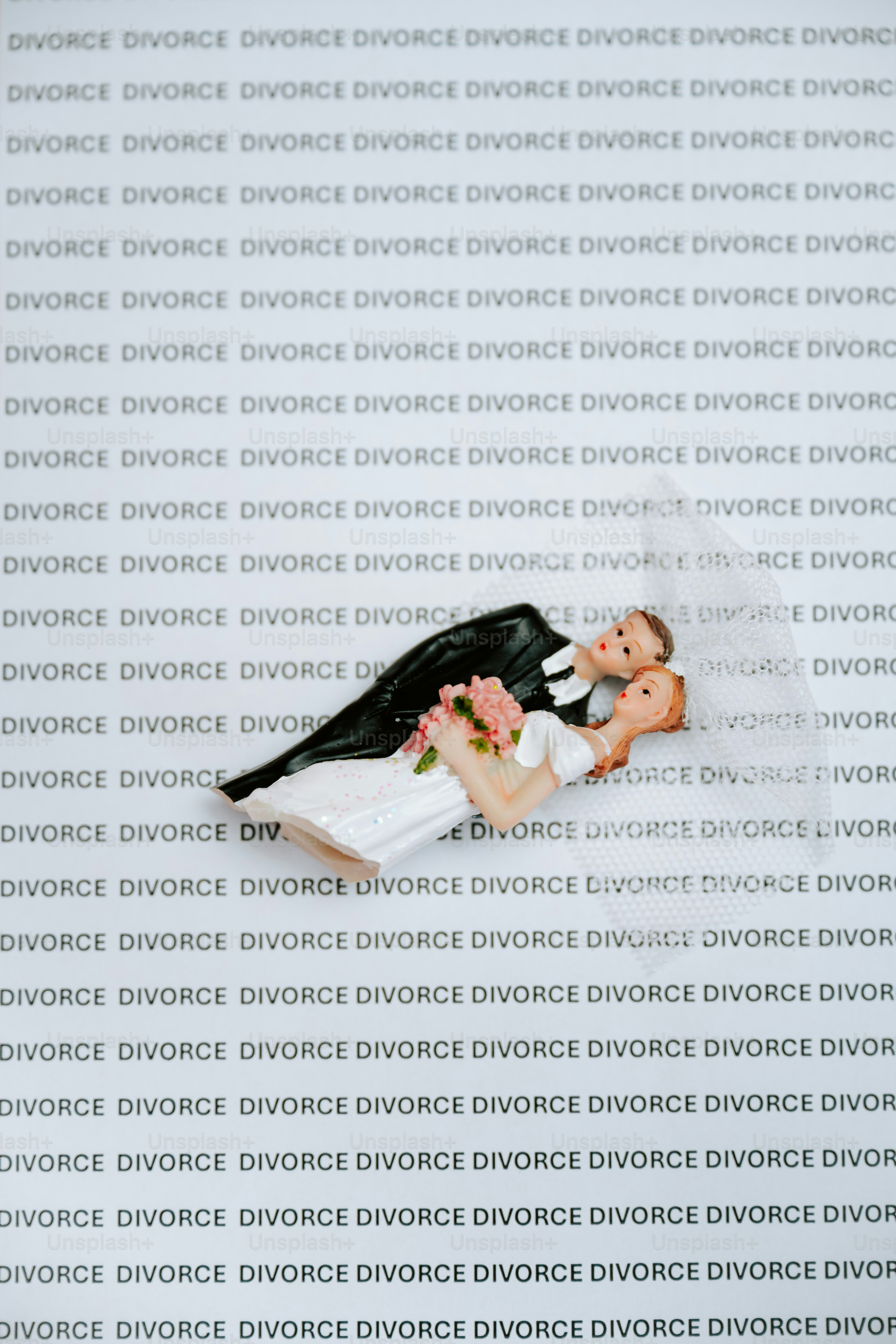Bride and groom cake topper on divorce background.