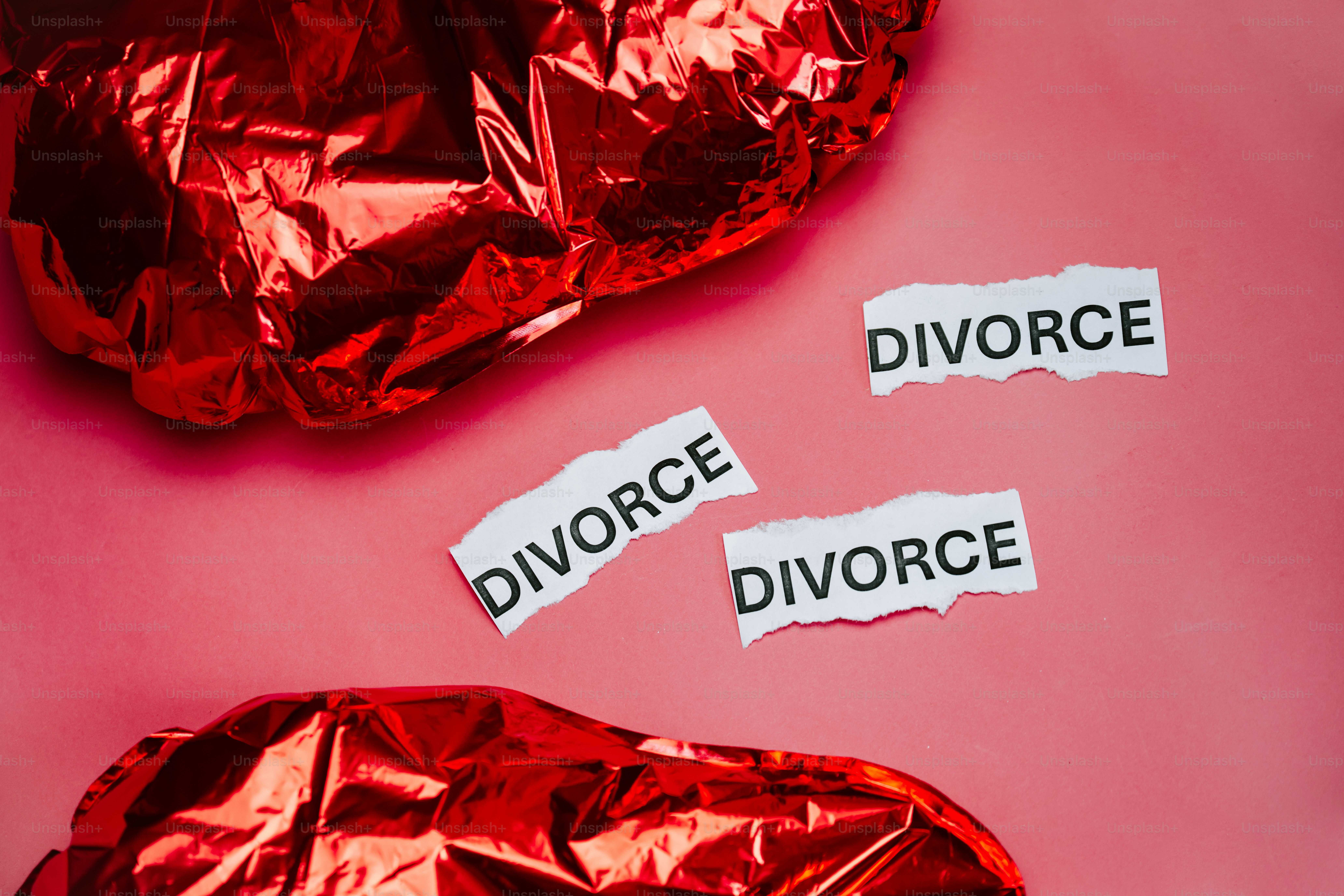 Torn paper with the word divorce on pink background