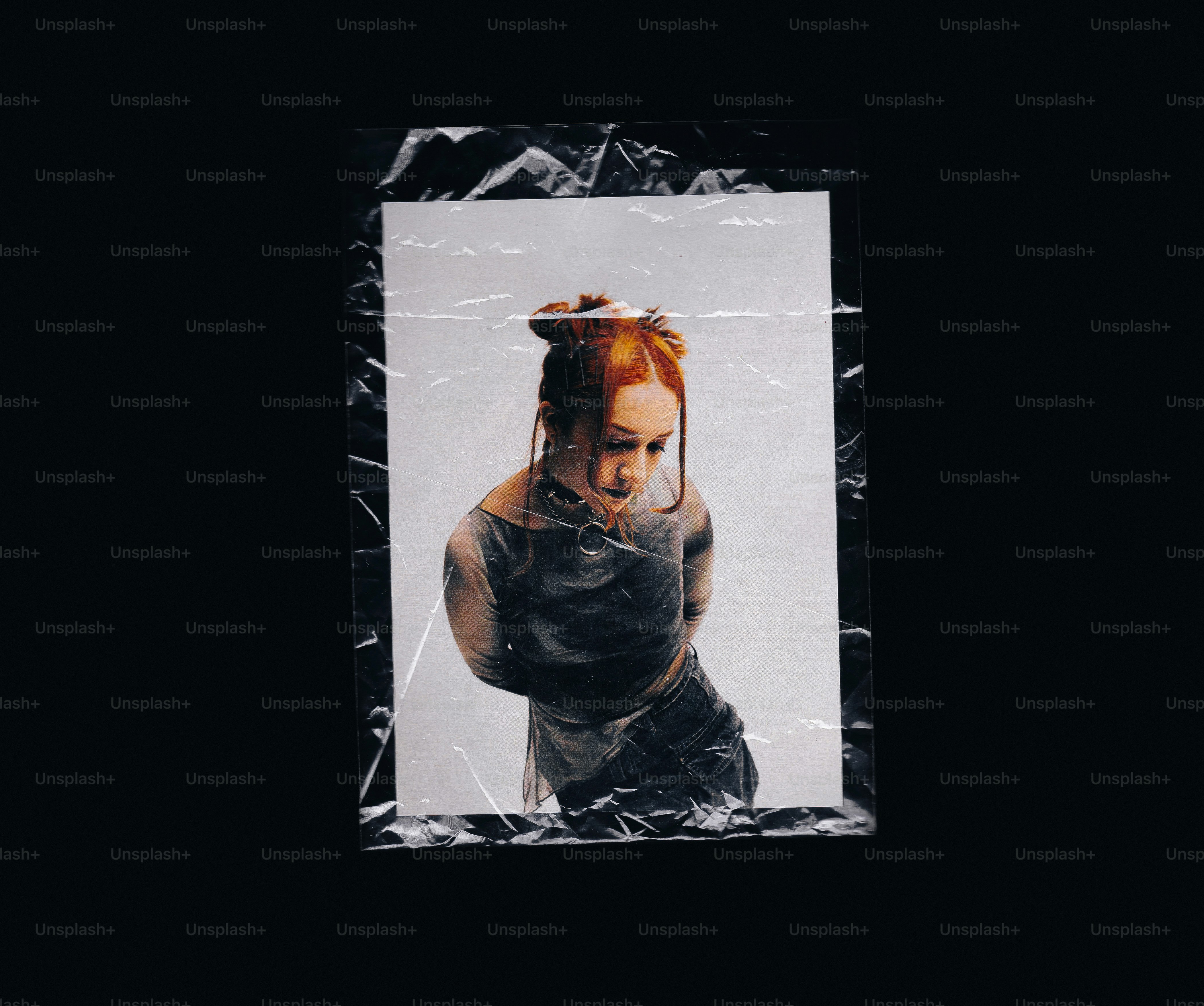 Woman with orange hair in a plastic-wrapped print.