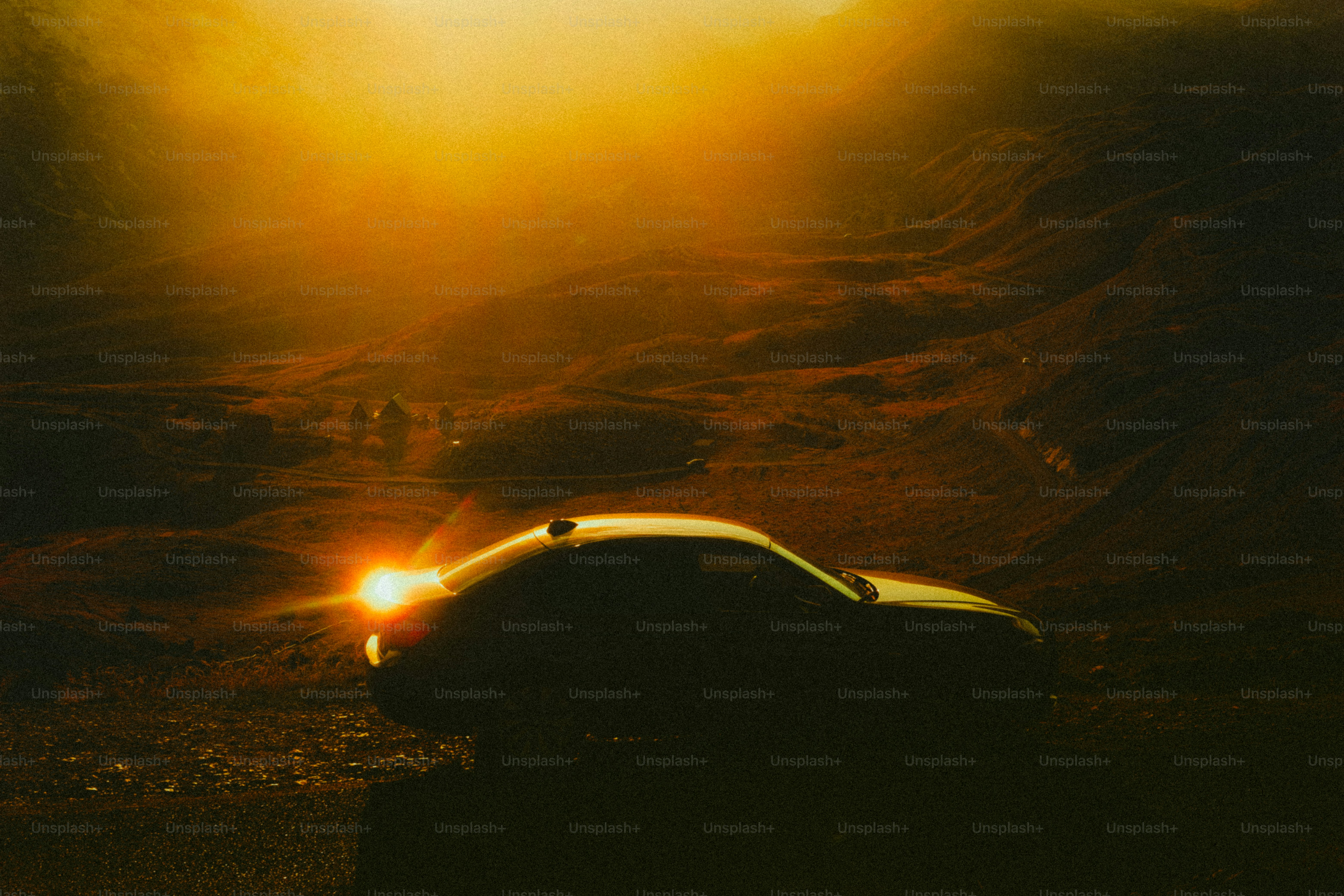 A car driving on a dirt road at sunset. photo – Abstract Image on Unsplash