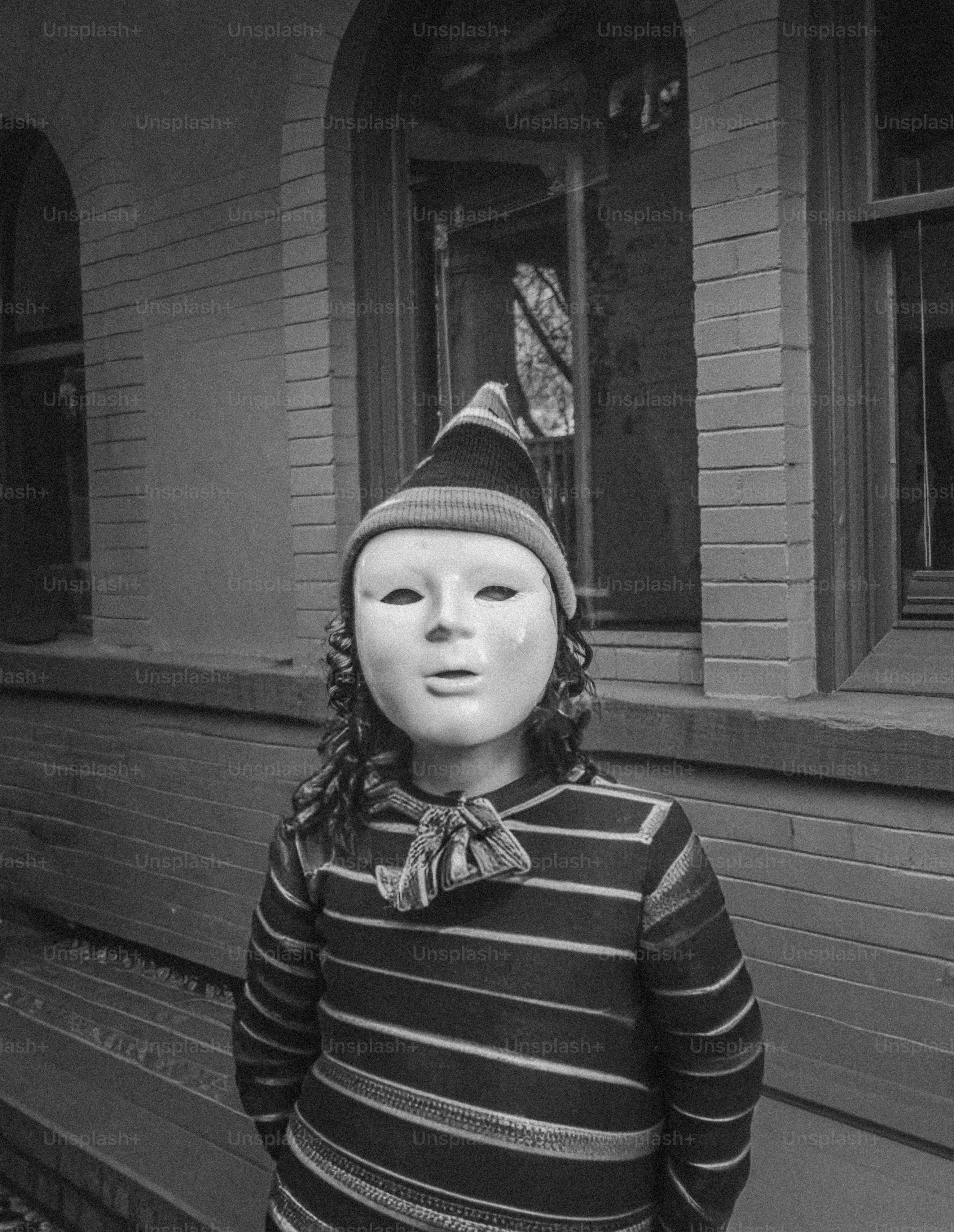 Child wearing a mask and striped sweater outdoors